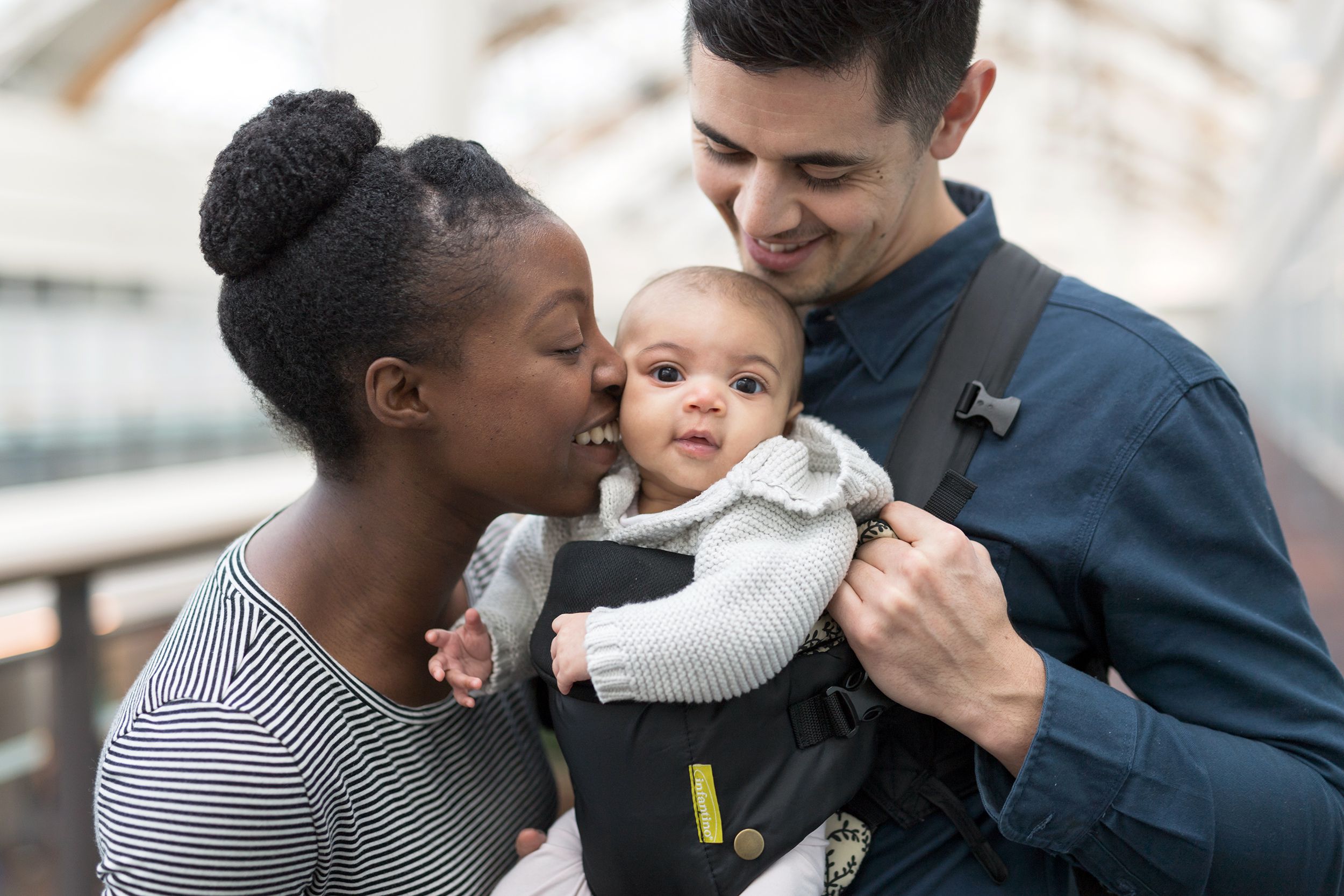 adoring parents with their baby in a shopping mall