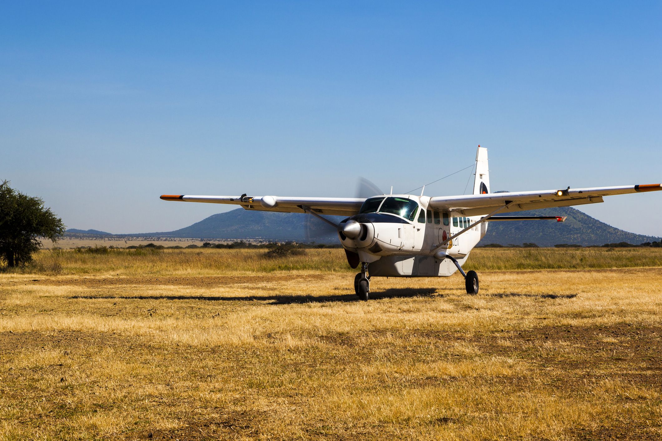Serengeti Tanzania - Jun 2, 2013: Group of tourists arriving in one of the Serengeti National Park airstrip, these small airfields are major hubs for tourism and also the industry supply route.