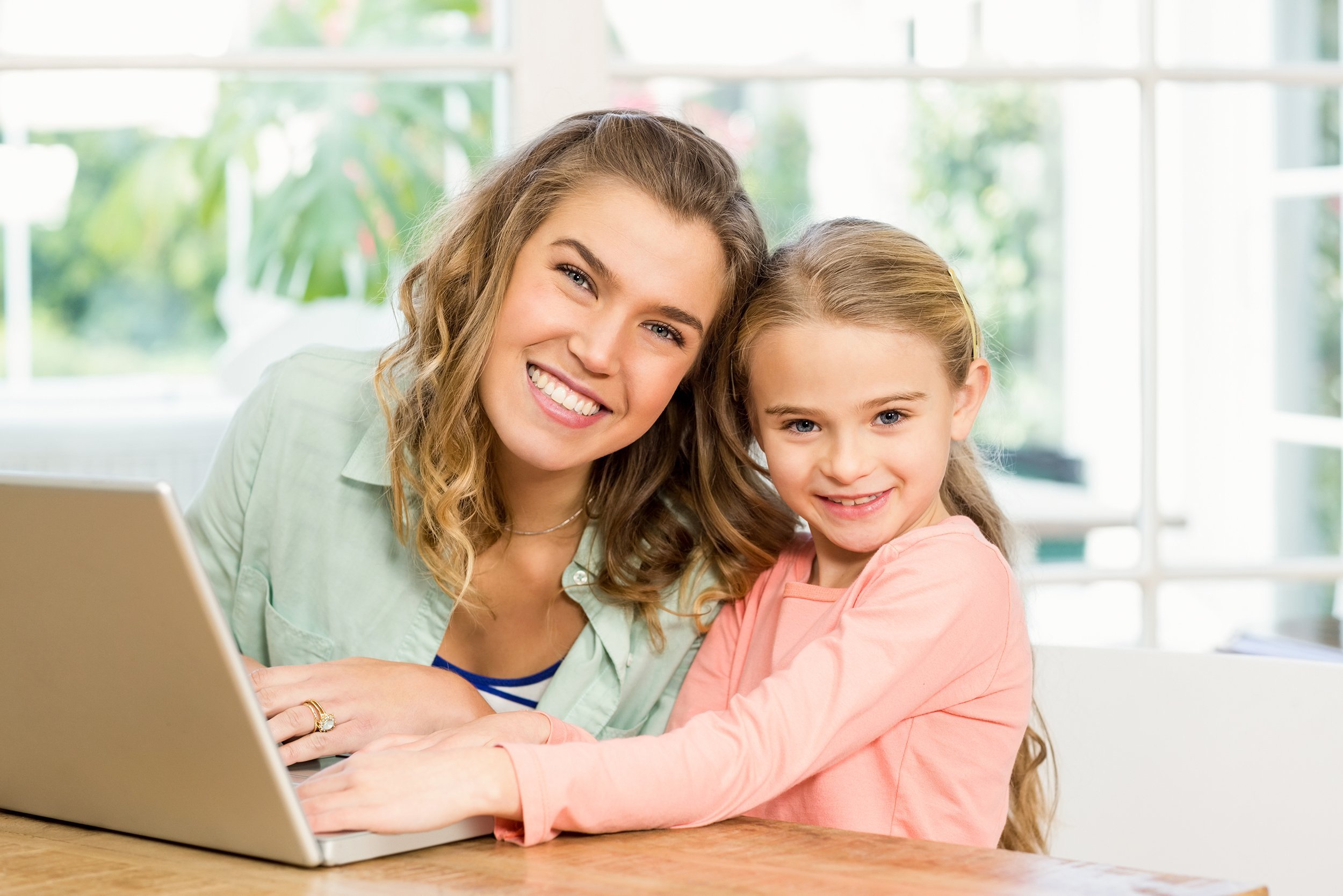 mother and daughter using laptop