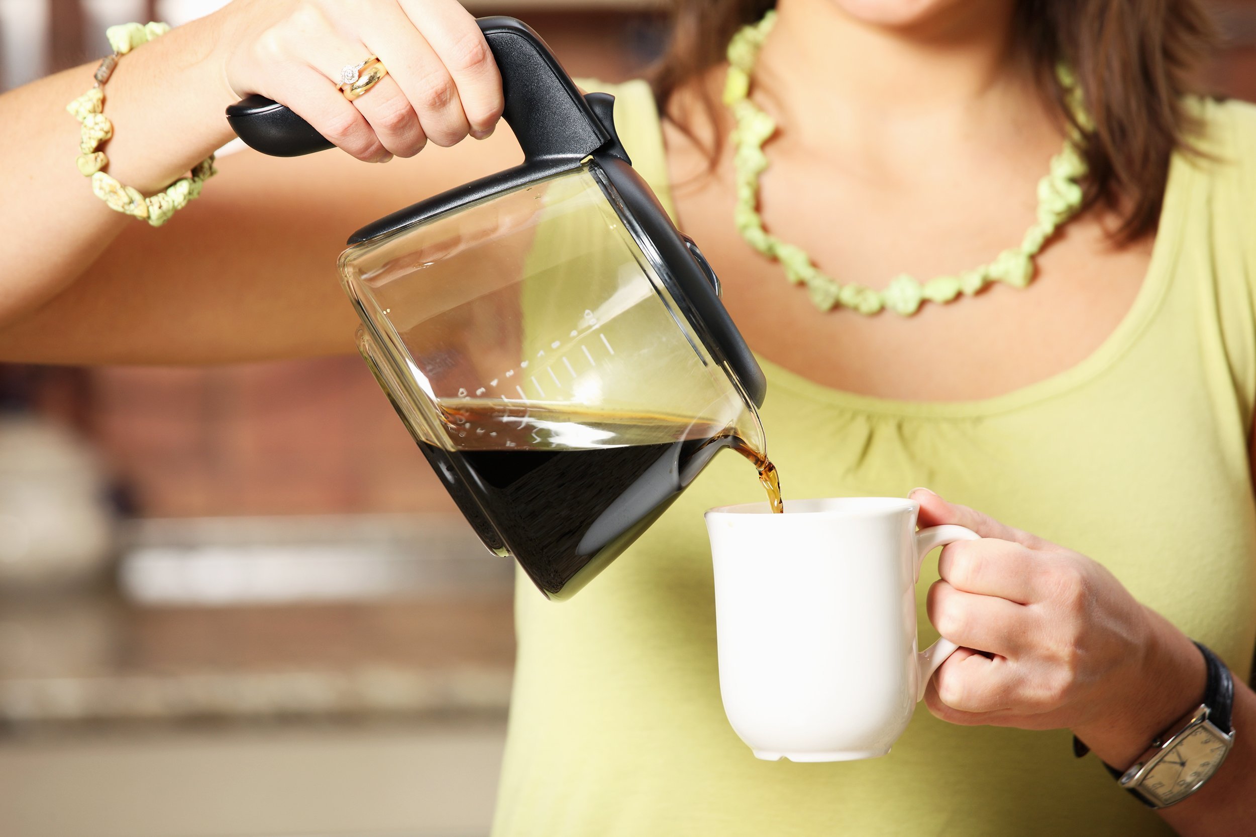woman pouring coffee into cup