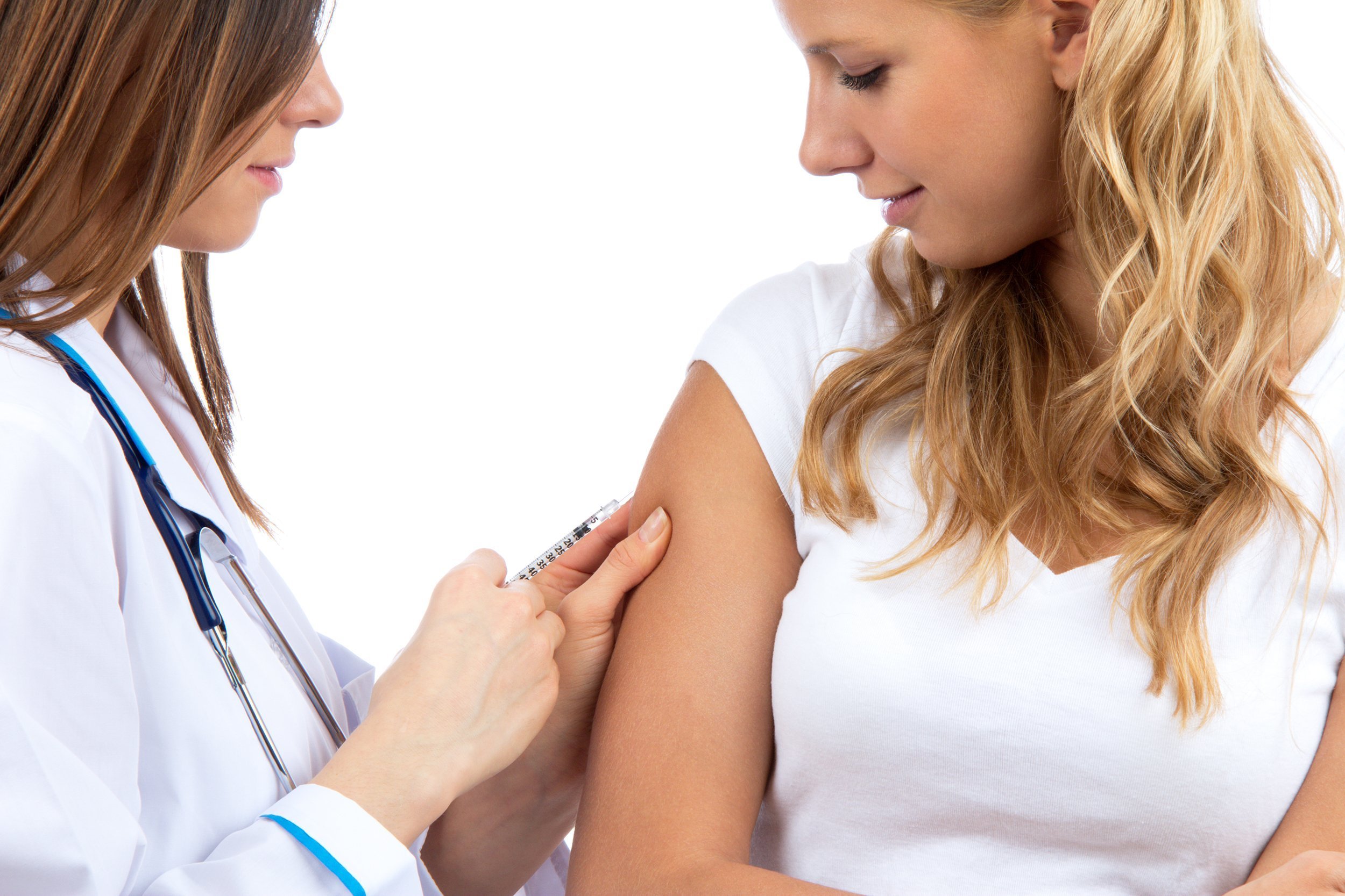 woman getting a flu shot from doctor