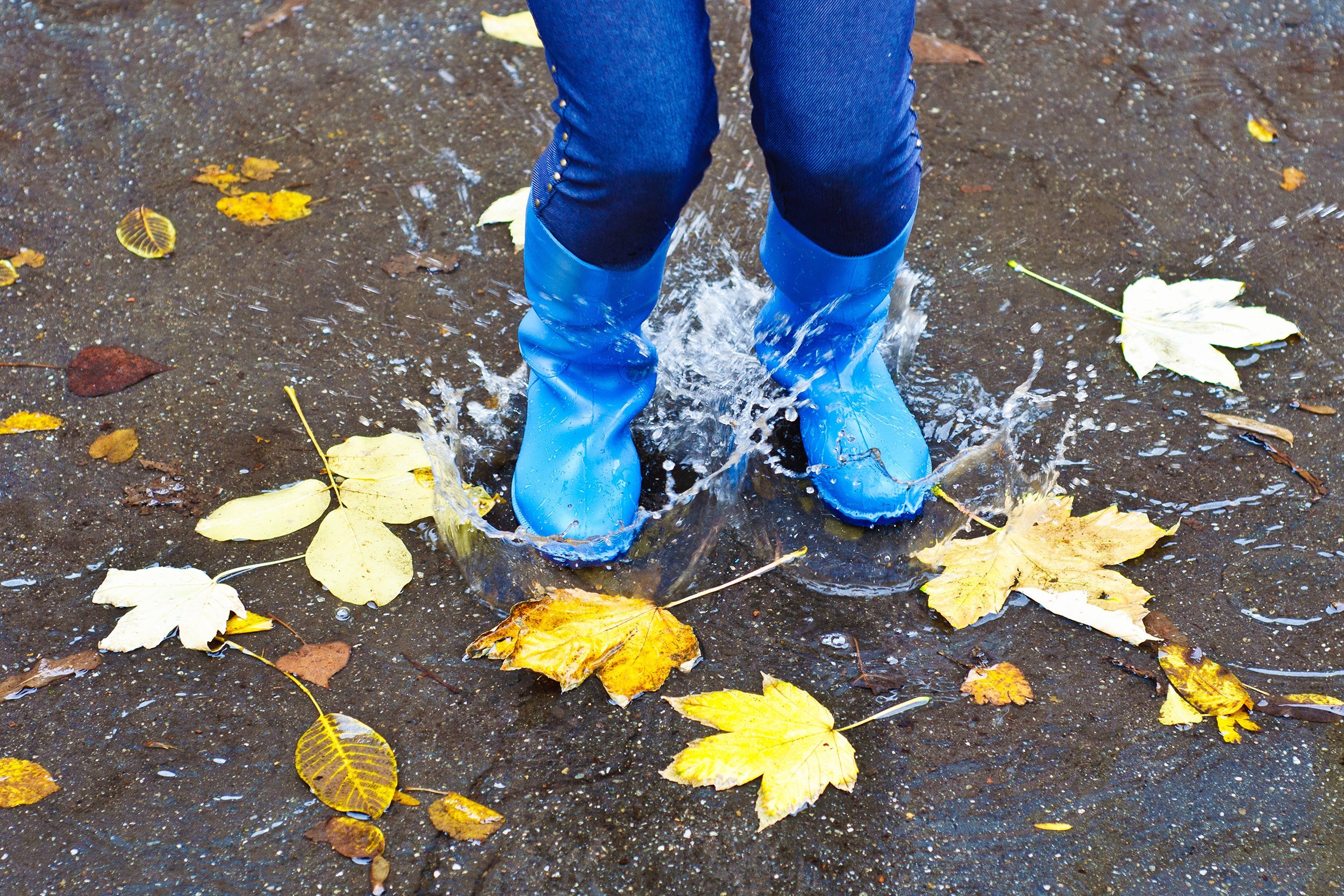 girl wearing rain boots in the fall