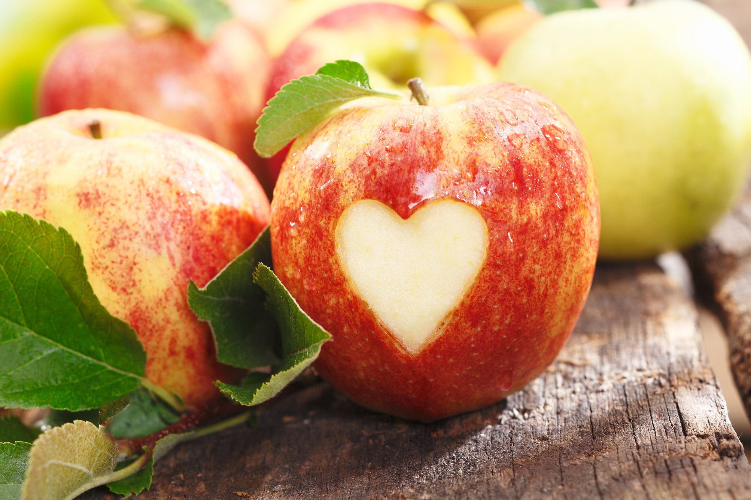 fresh red apples on a wooden table