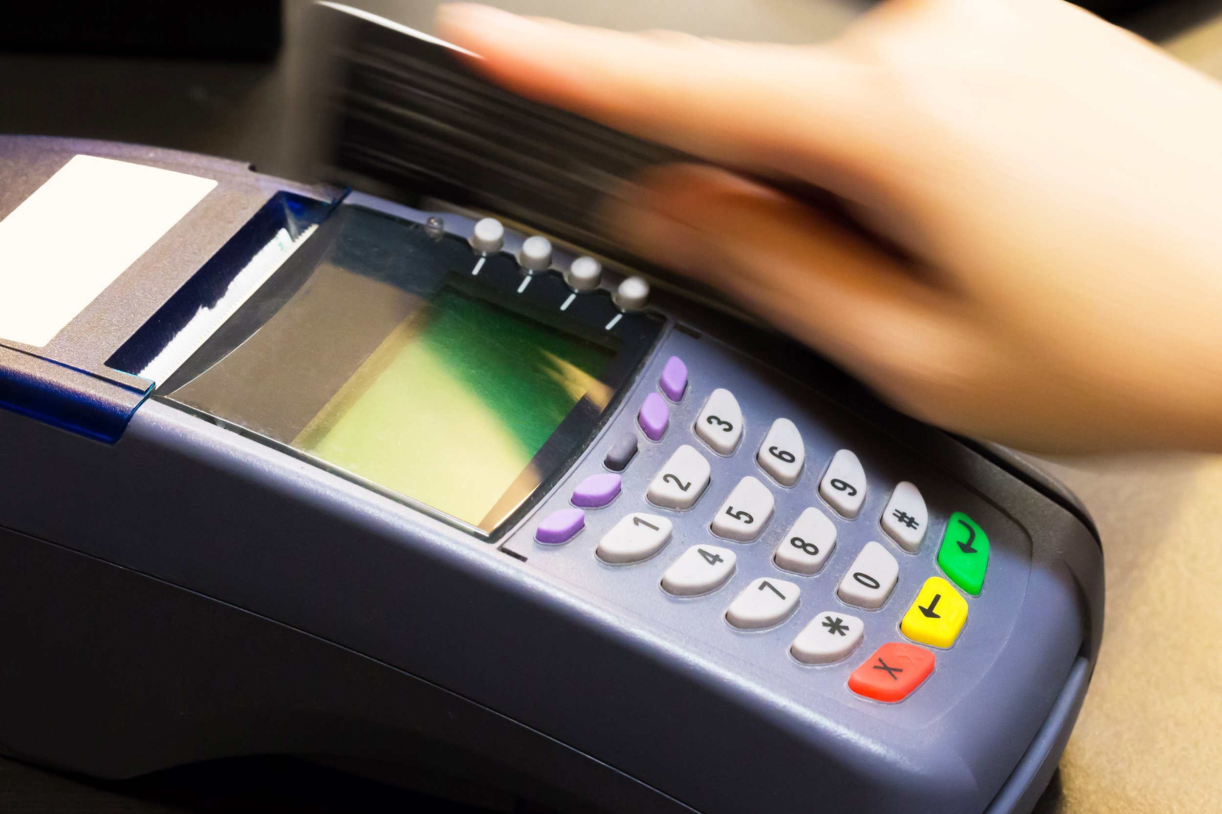 hand swiping credit card in store