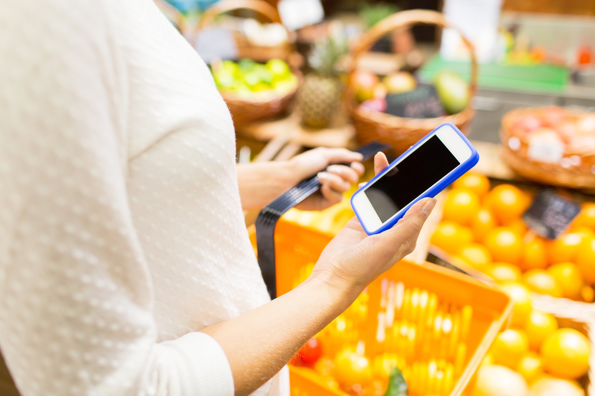 close up of young woman with food basket in market