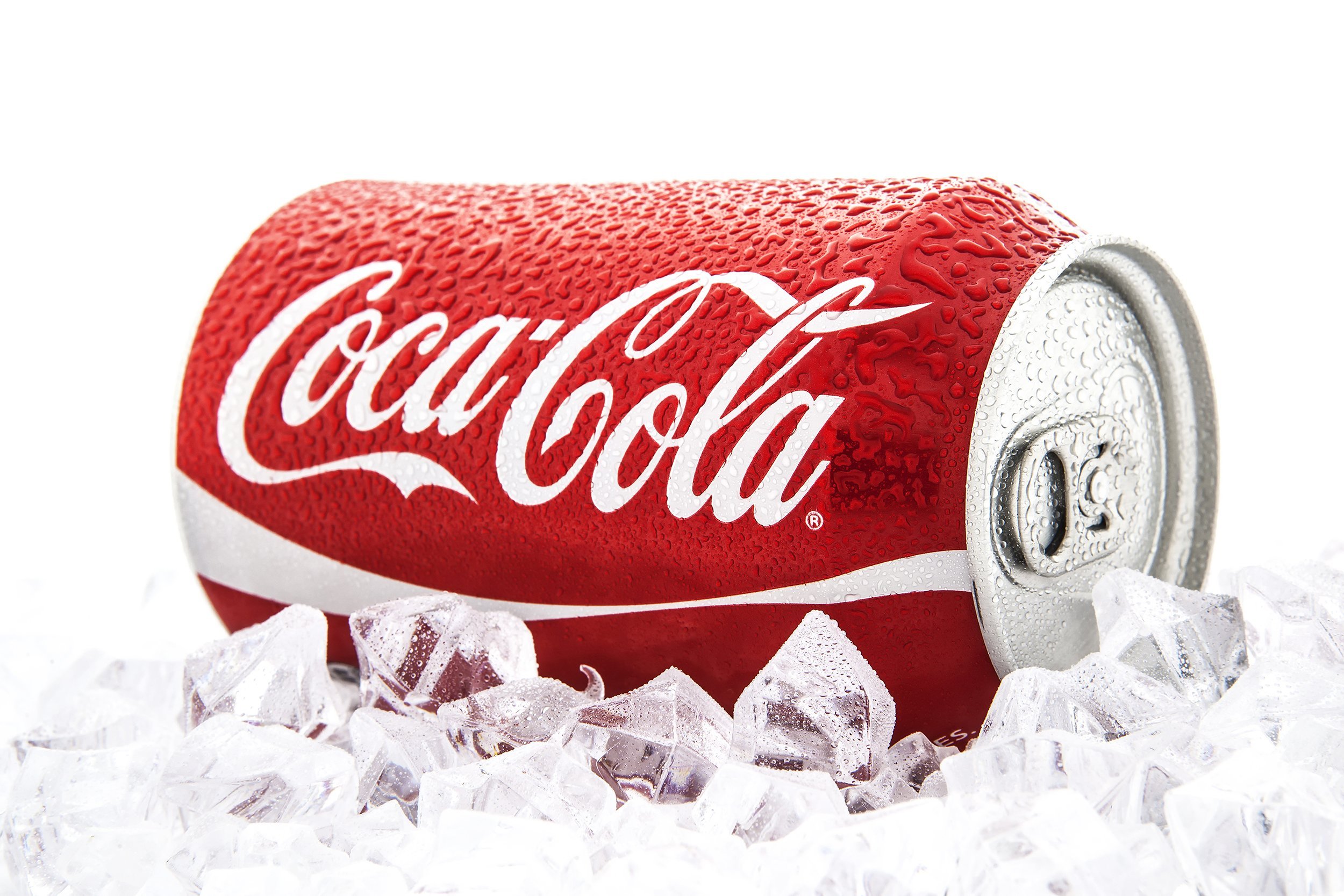 can of coca-cola on a bed of ice