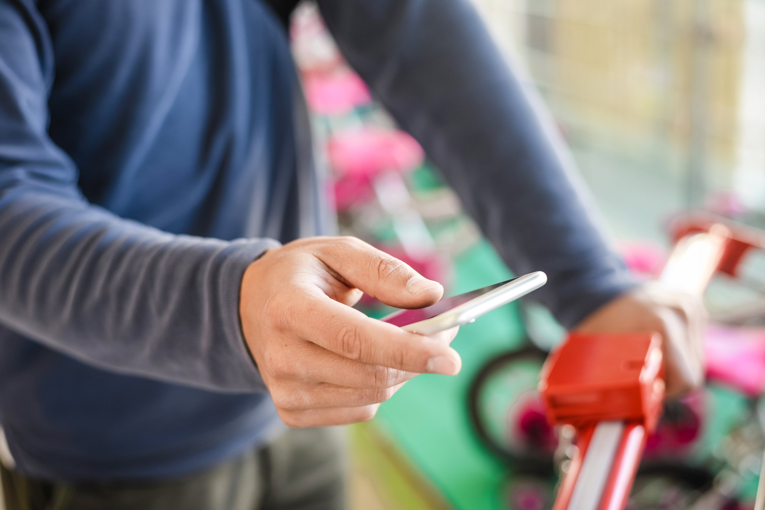 closeup on person holding mobile phone in hand during shopping