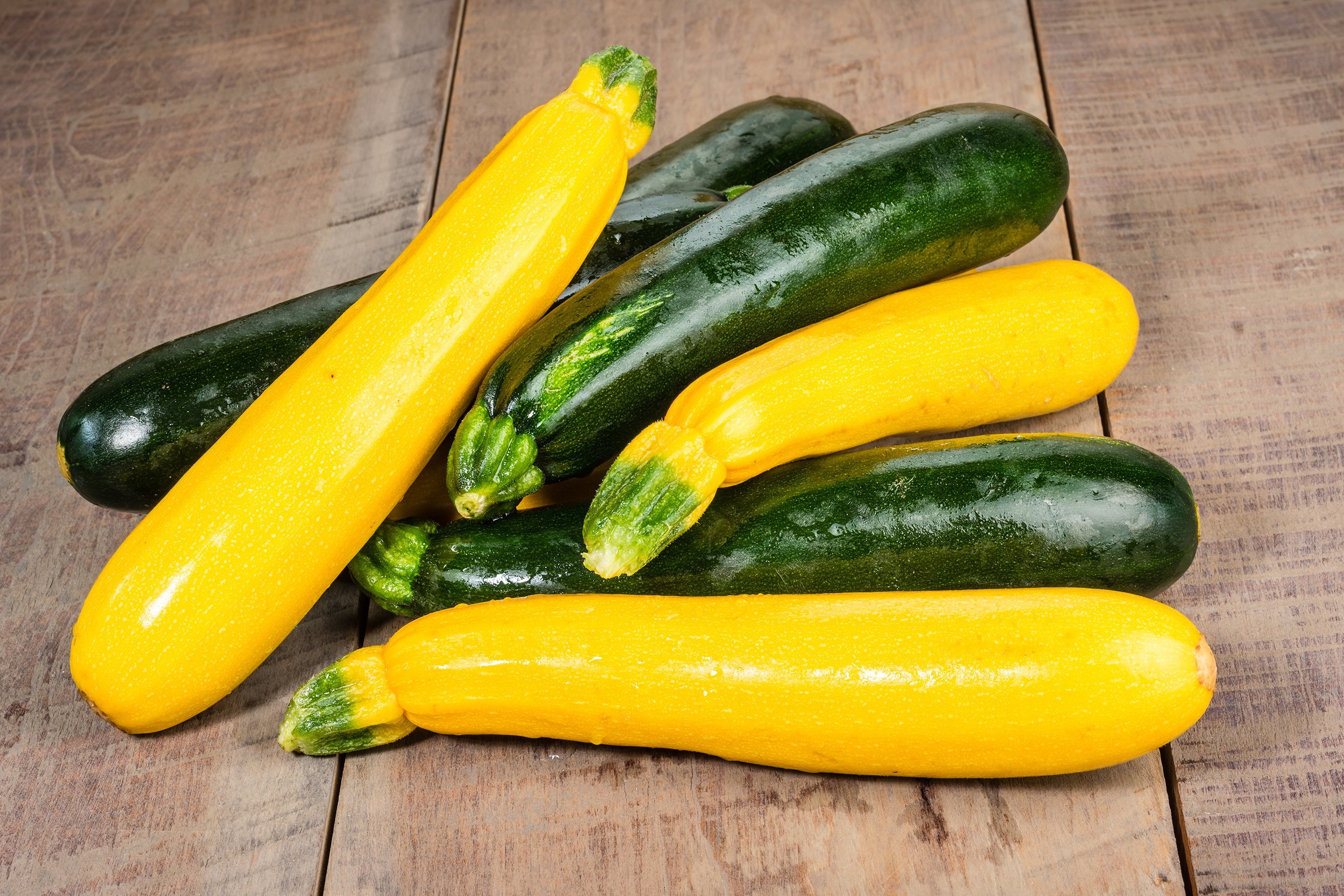 zucchini and yellow squash on a wooden table