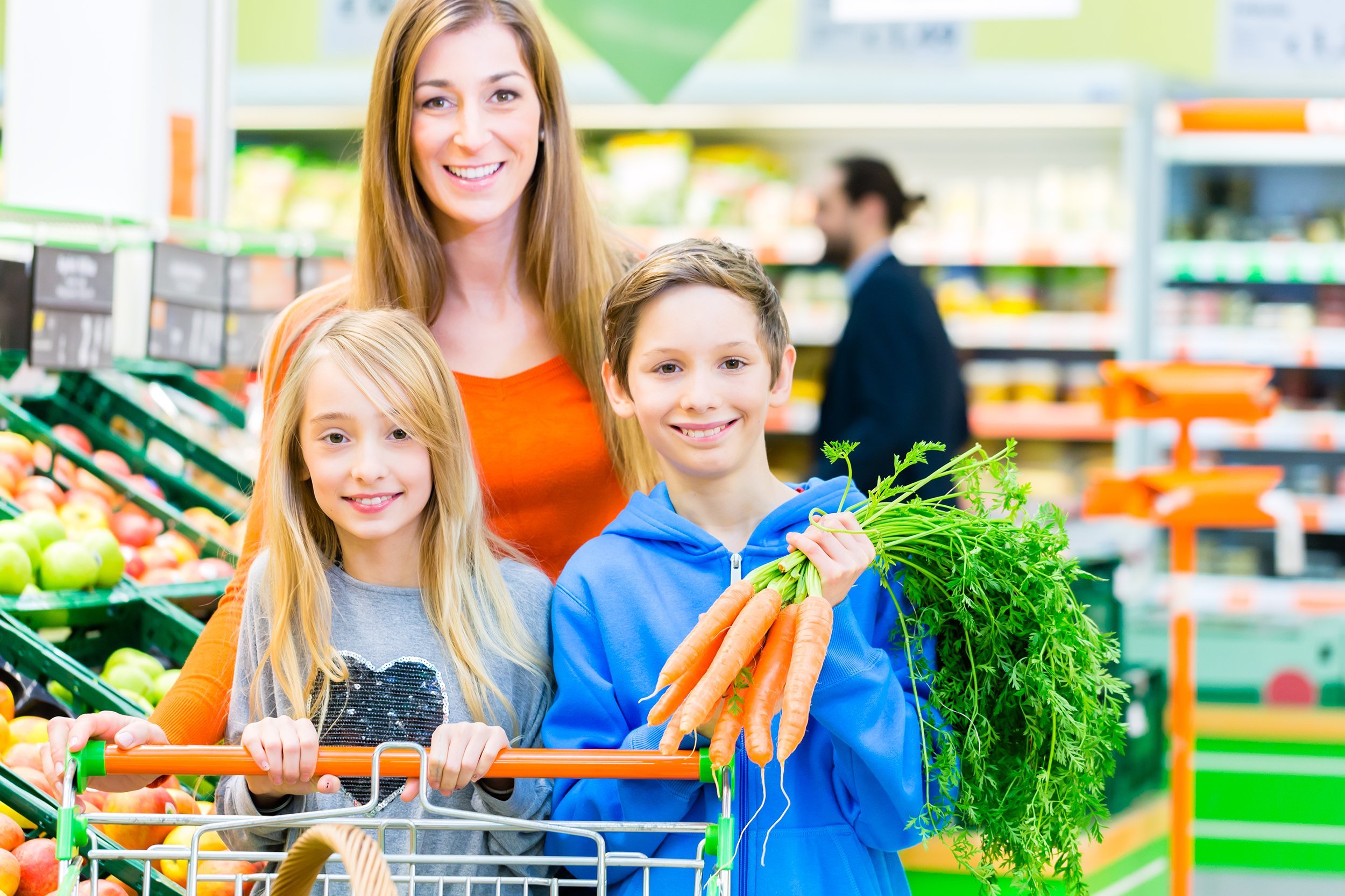 family selecting fruits and vegetables while grocery shopping