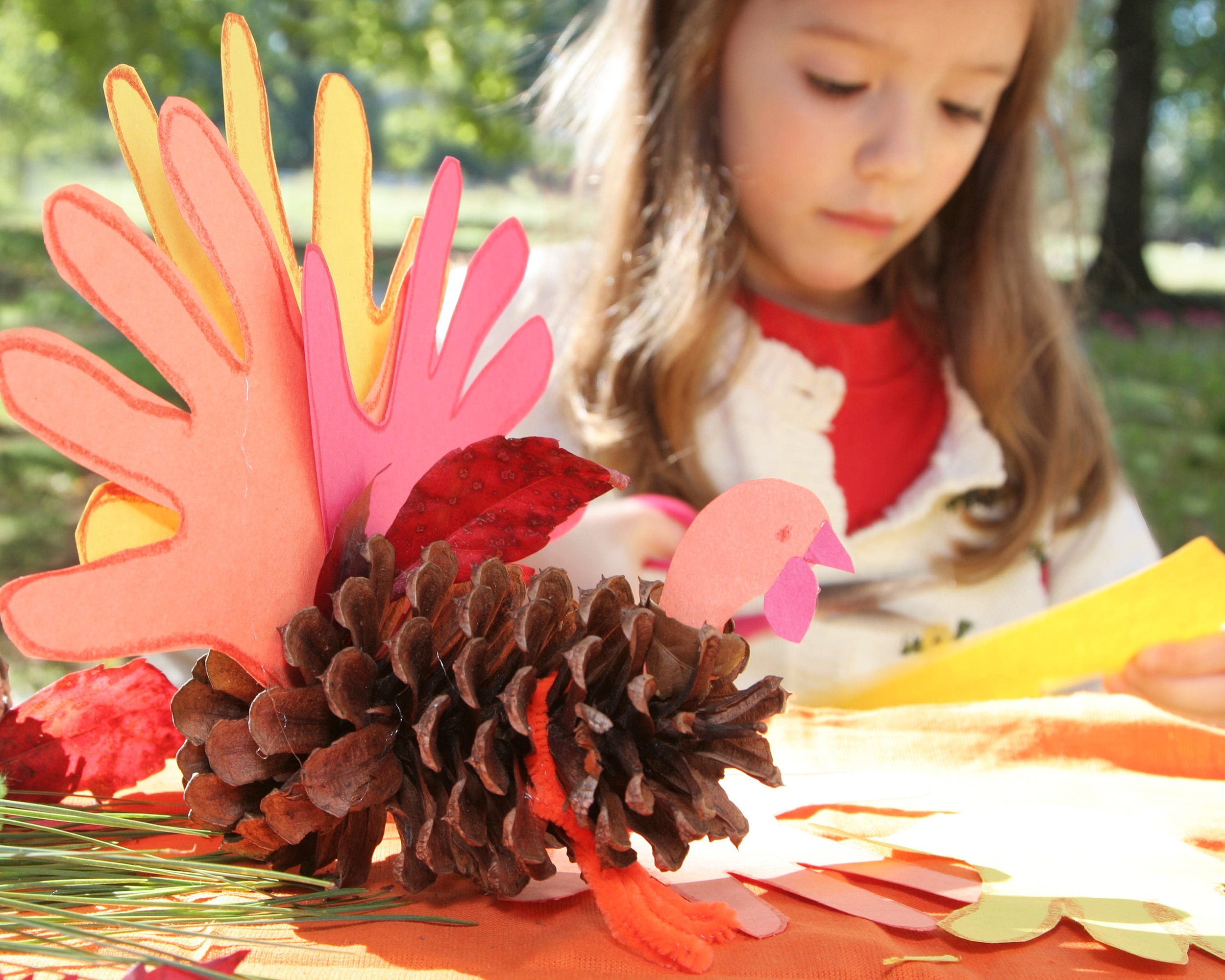 little girl making thanksgiving art project