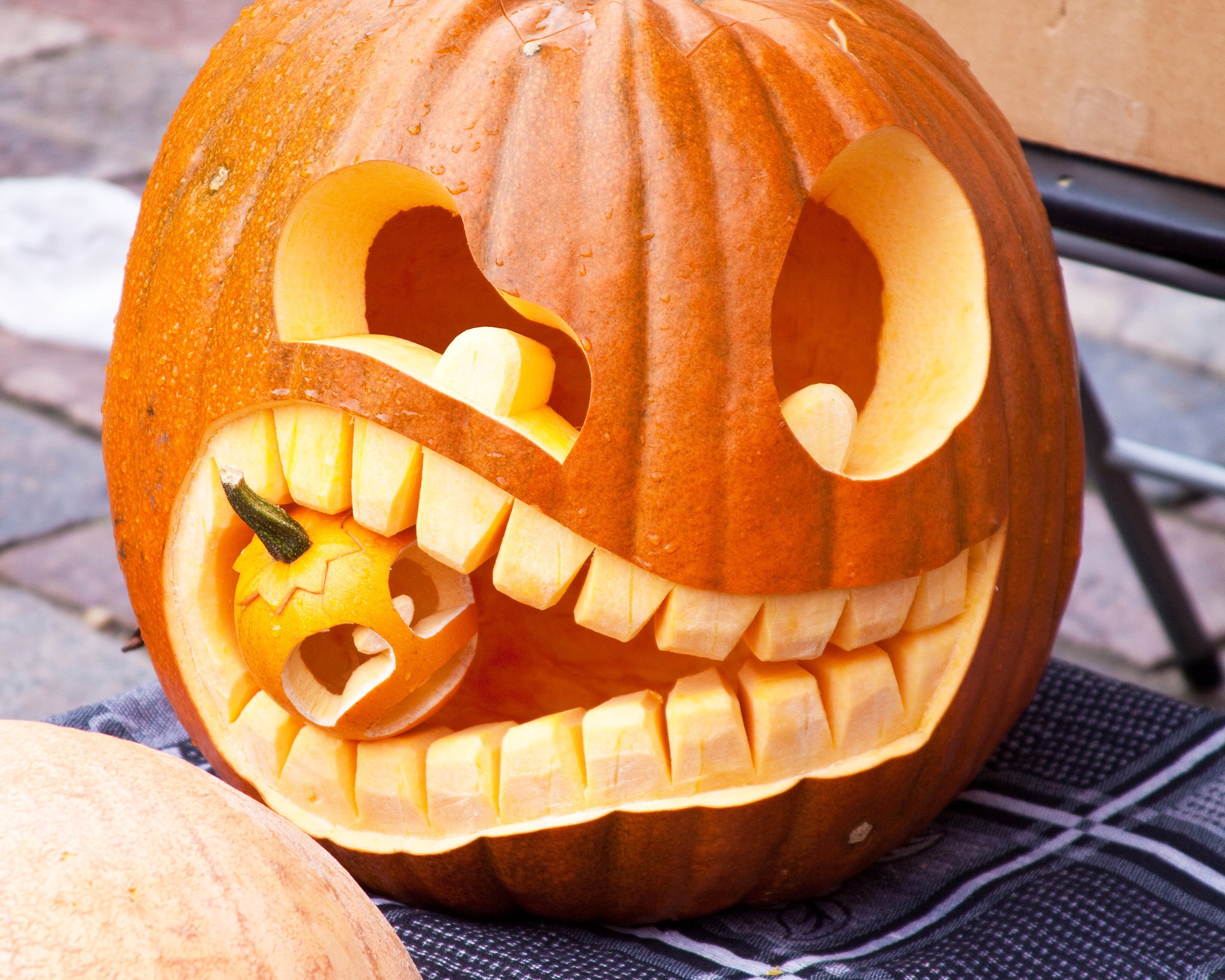 Halloween pumpkin eating small pumpkin