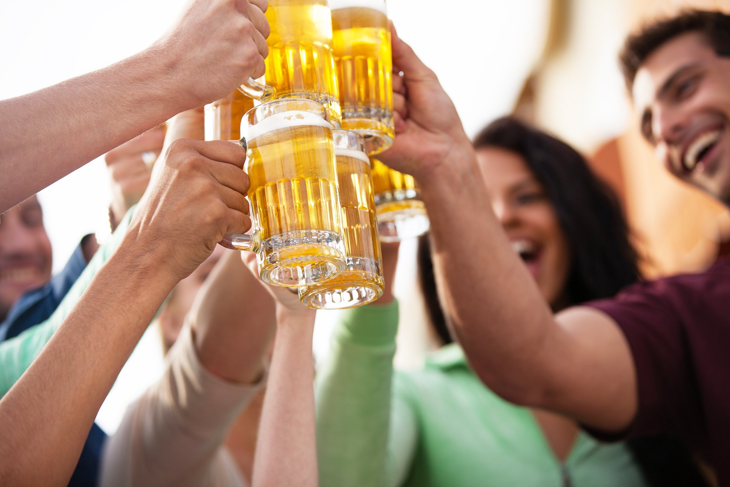 people toasting with beer