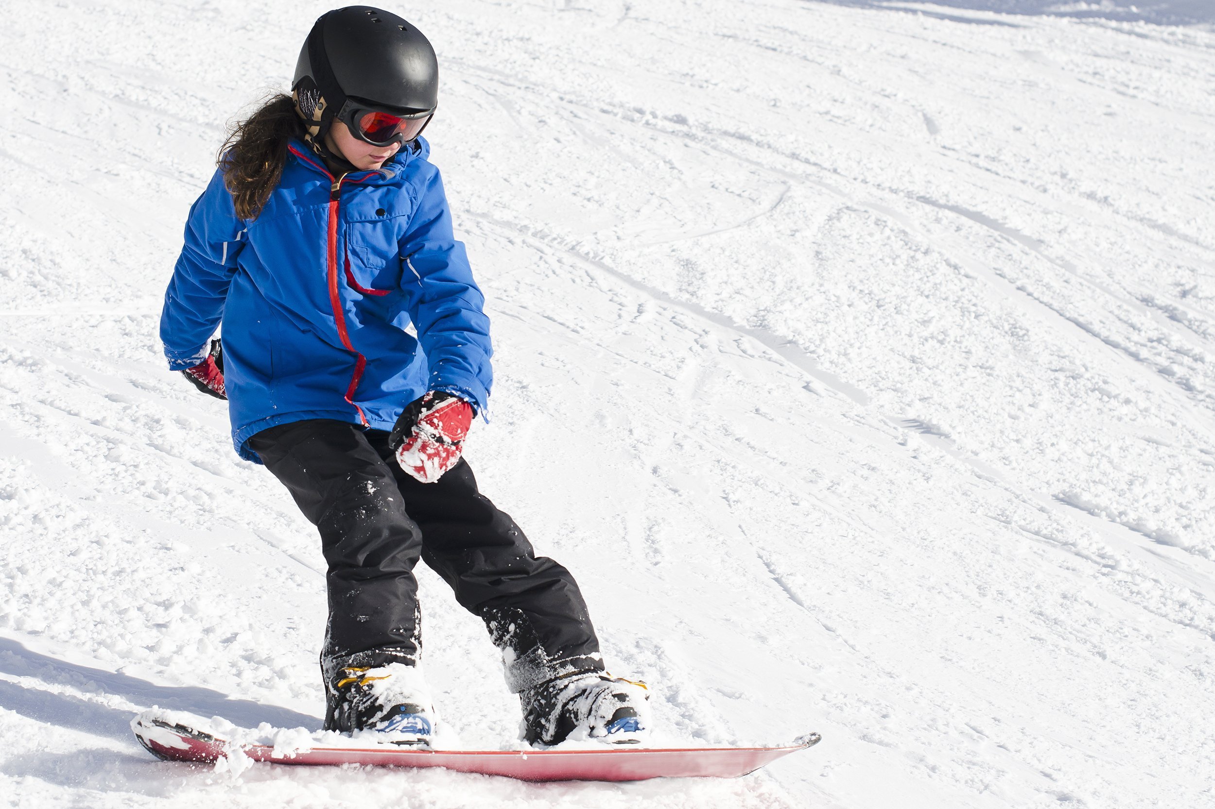 young girl snowboarding