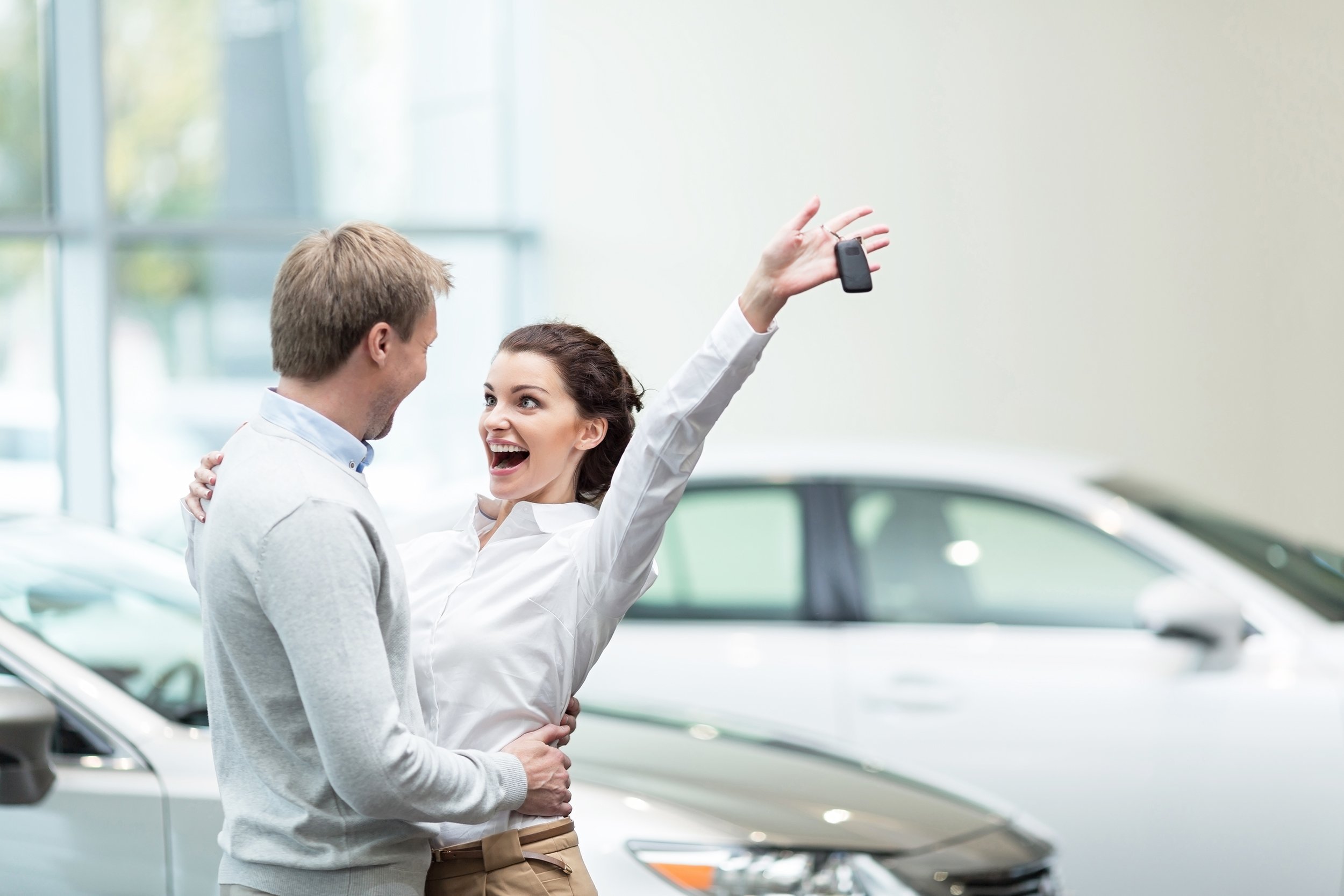 embracing couple with car keys
