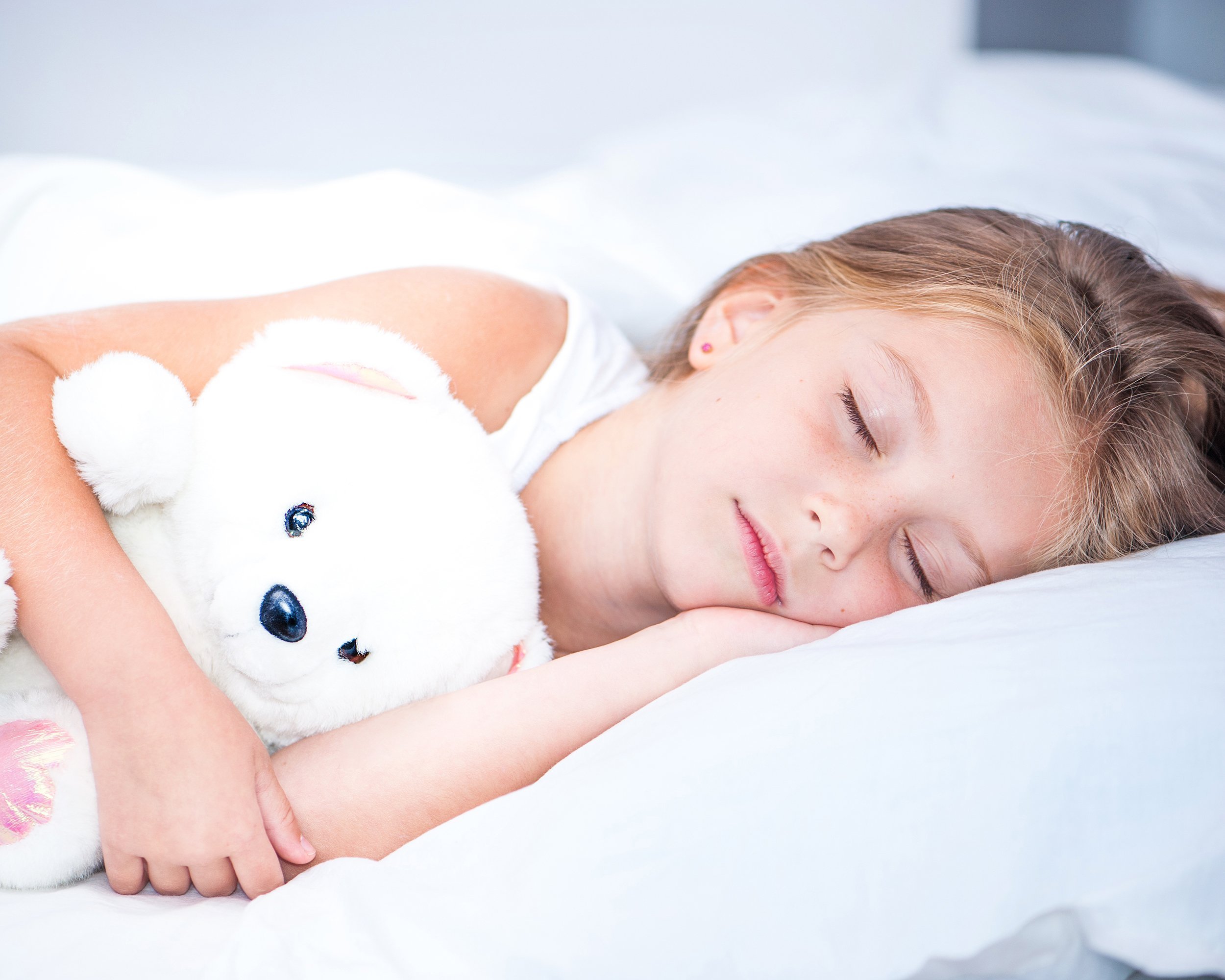 little girl sleeping in bed