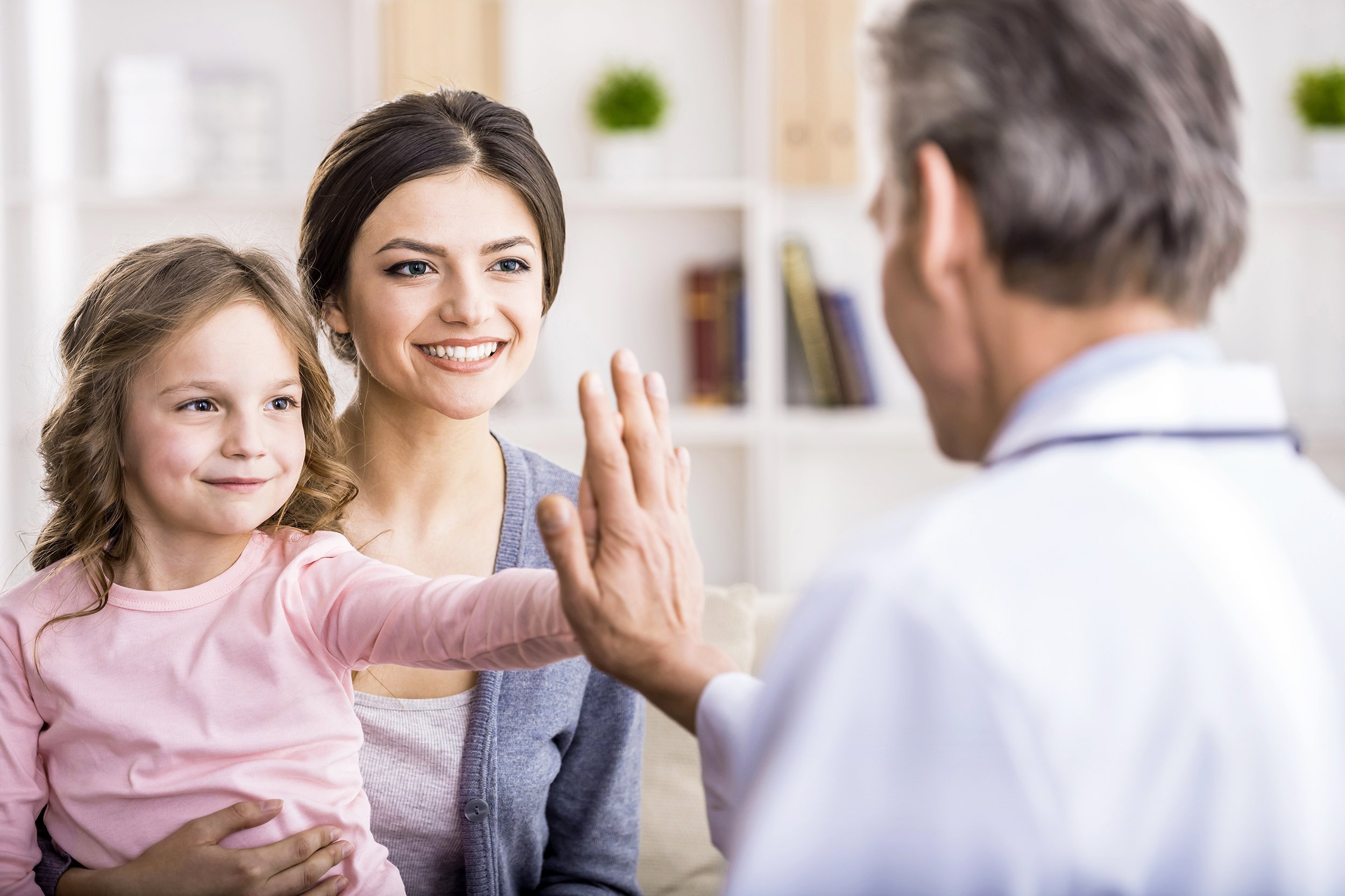 little girl with her mother at a doctor on consultation