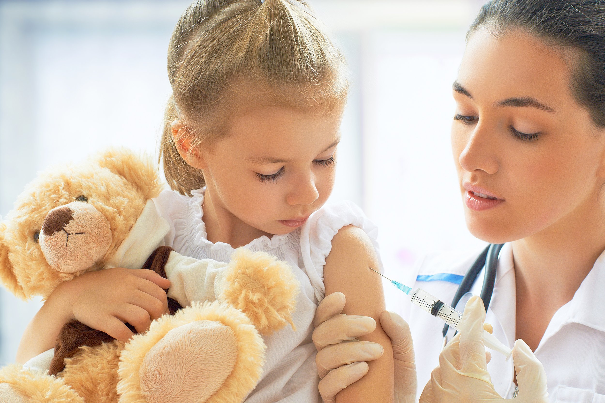 doctor giving a child a vaccine