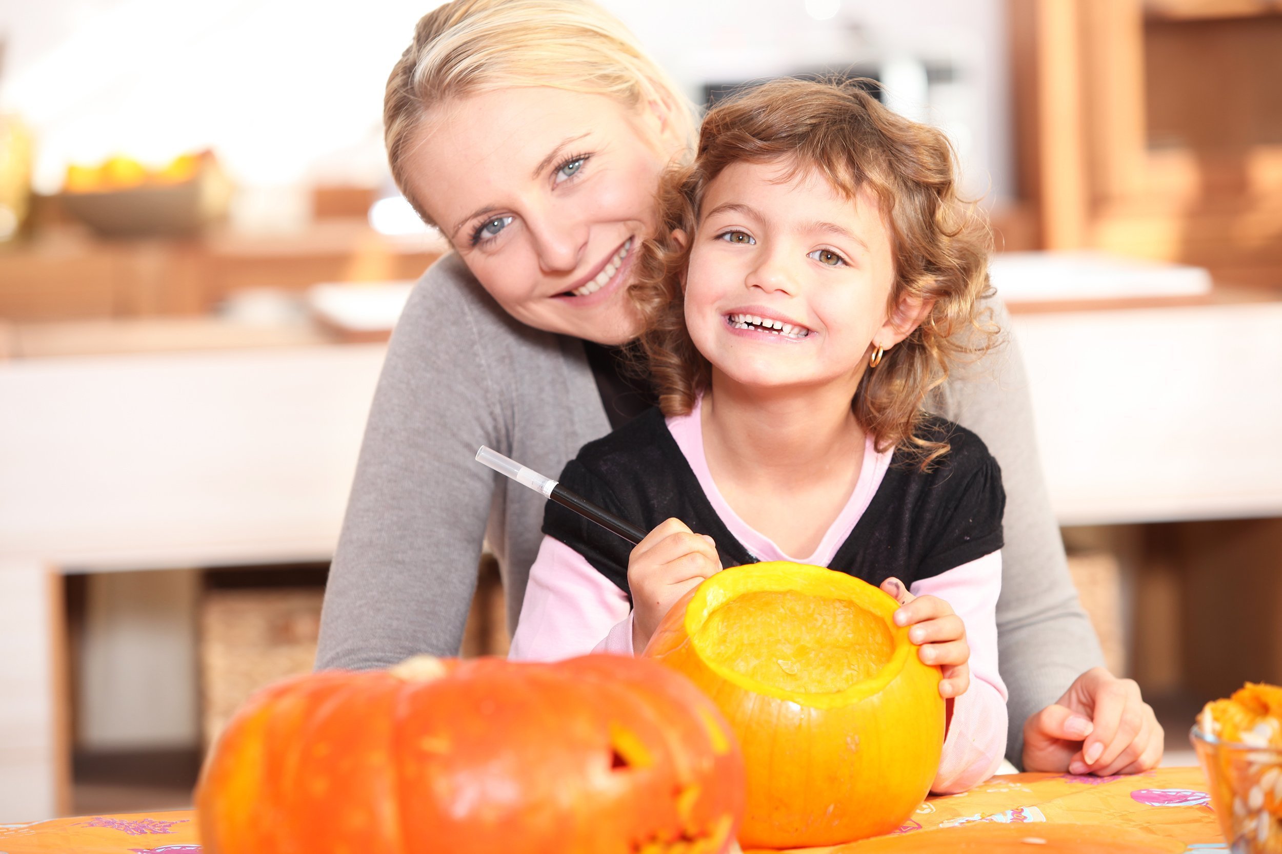 mother and daughter pumpkin carving