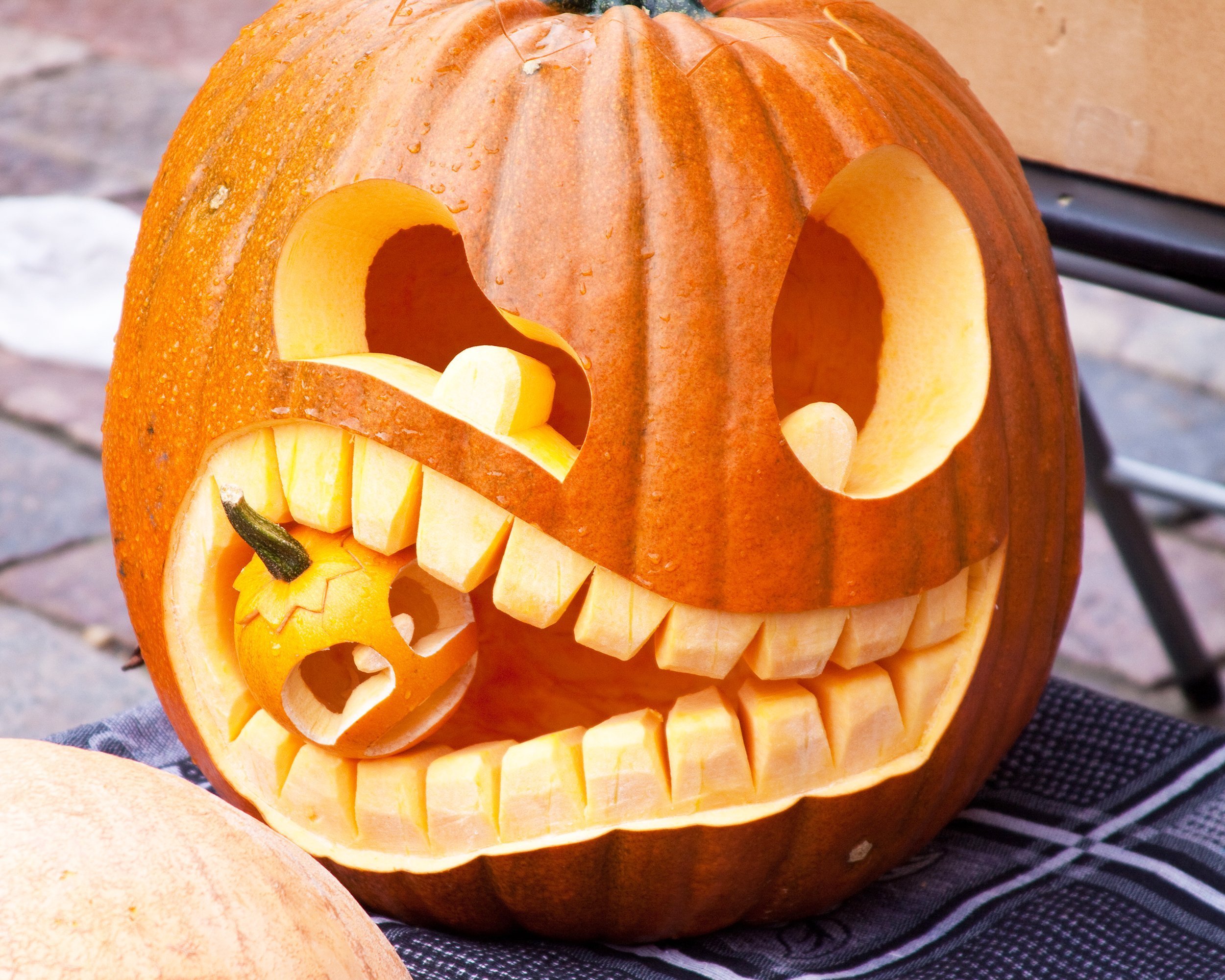 Halloween pumpkin eating small pumpkin