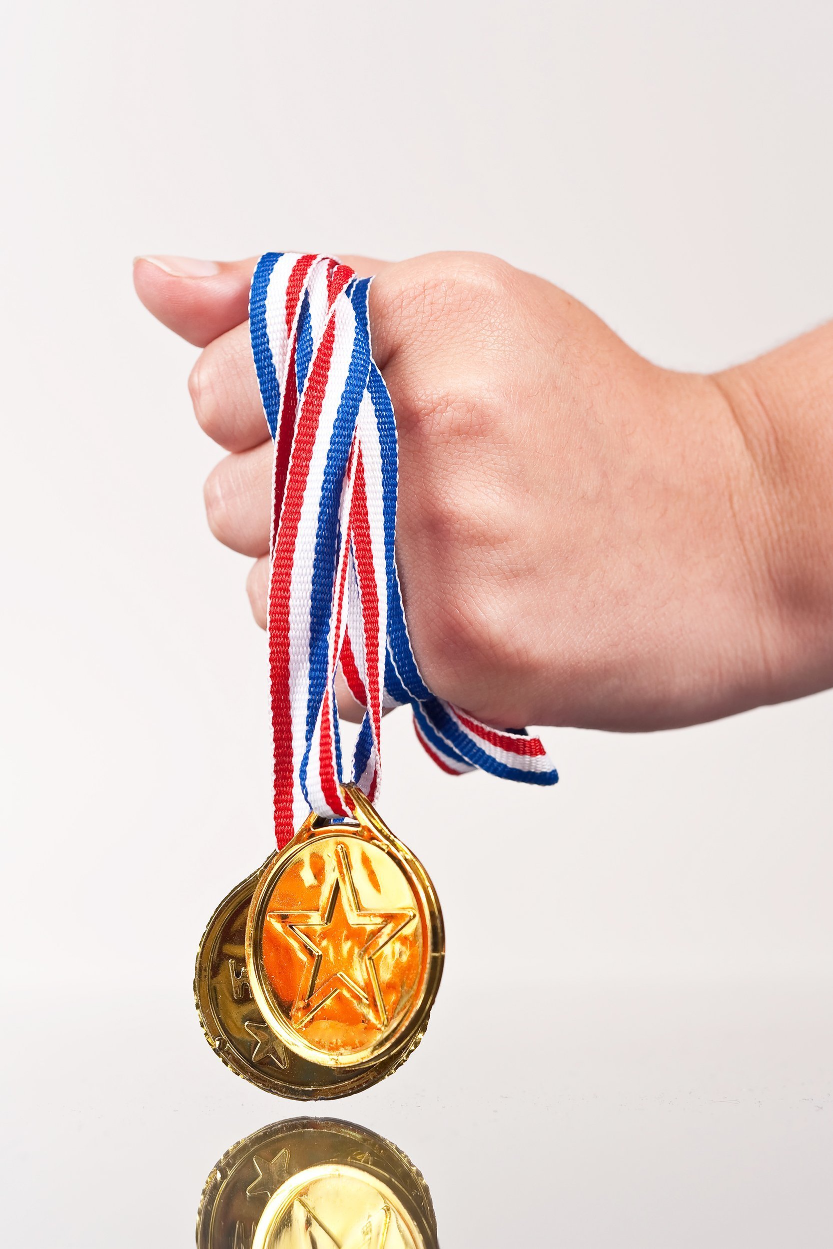 girl clutching fake gold medals