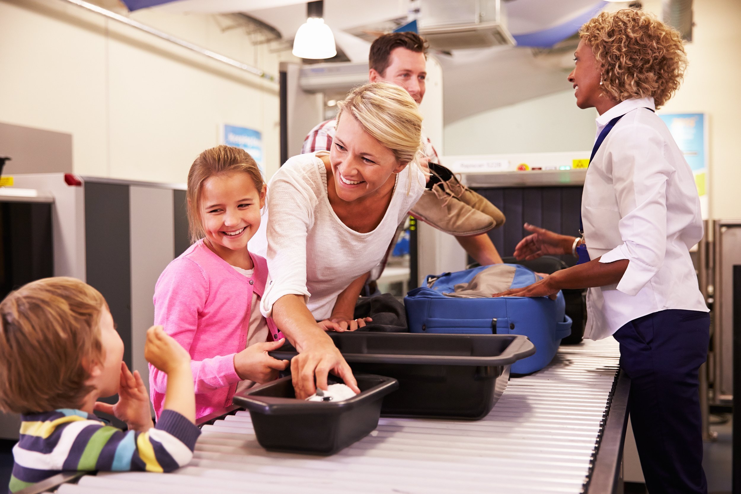 family at airport passing through security check