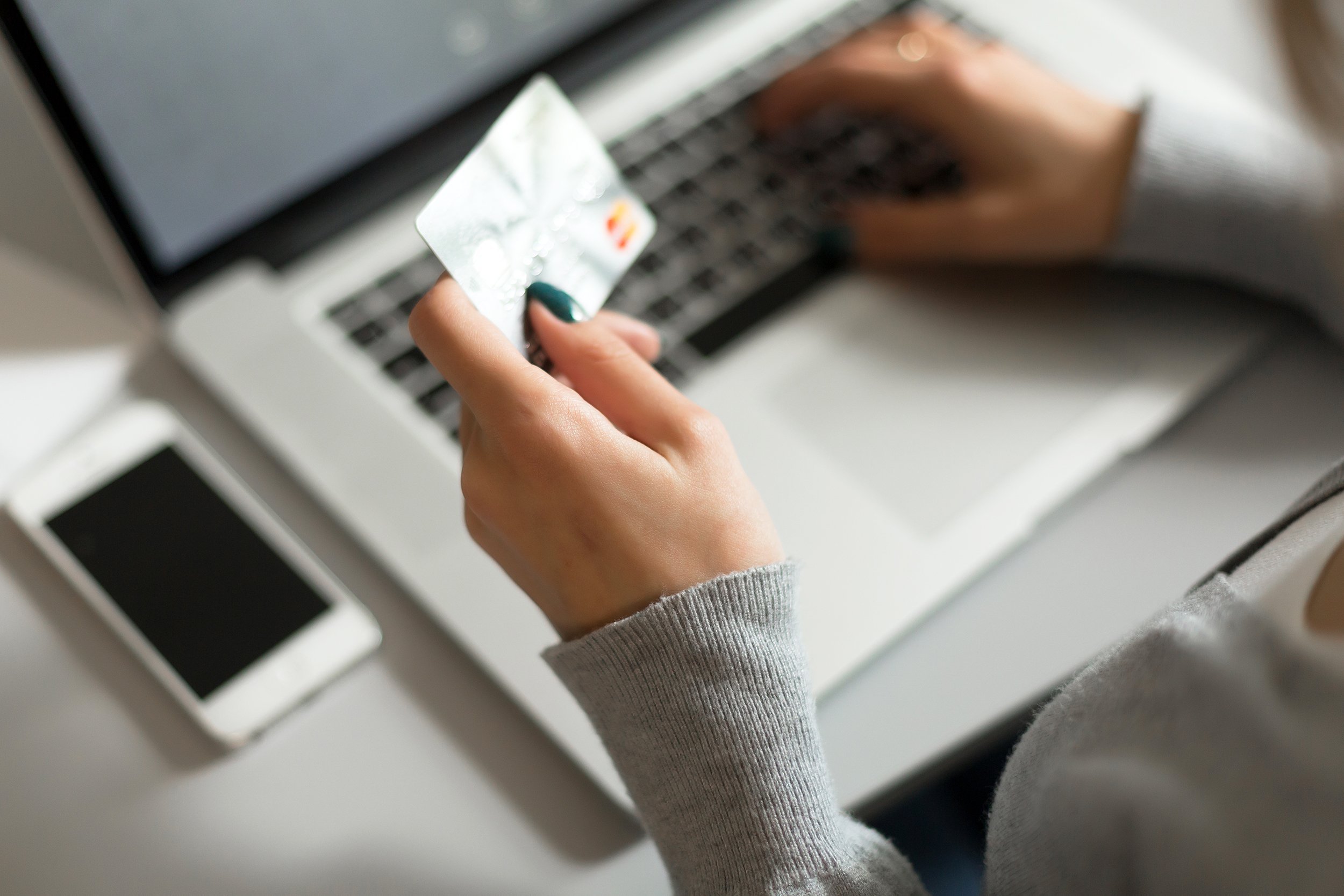 hands of woman shopping on the internet with credit card