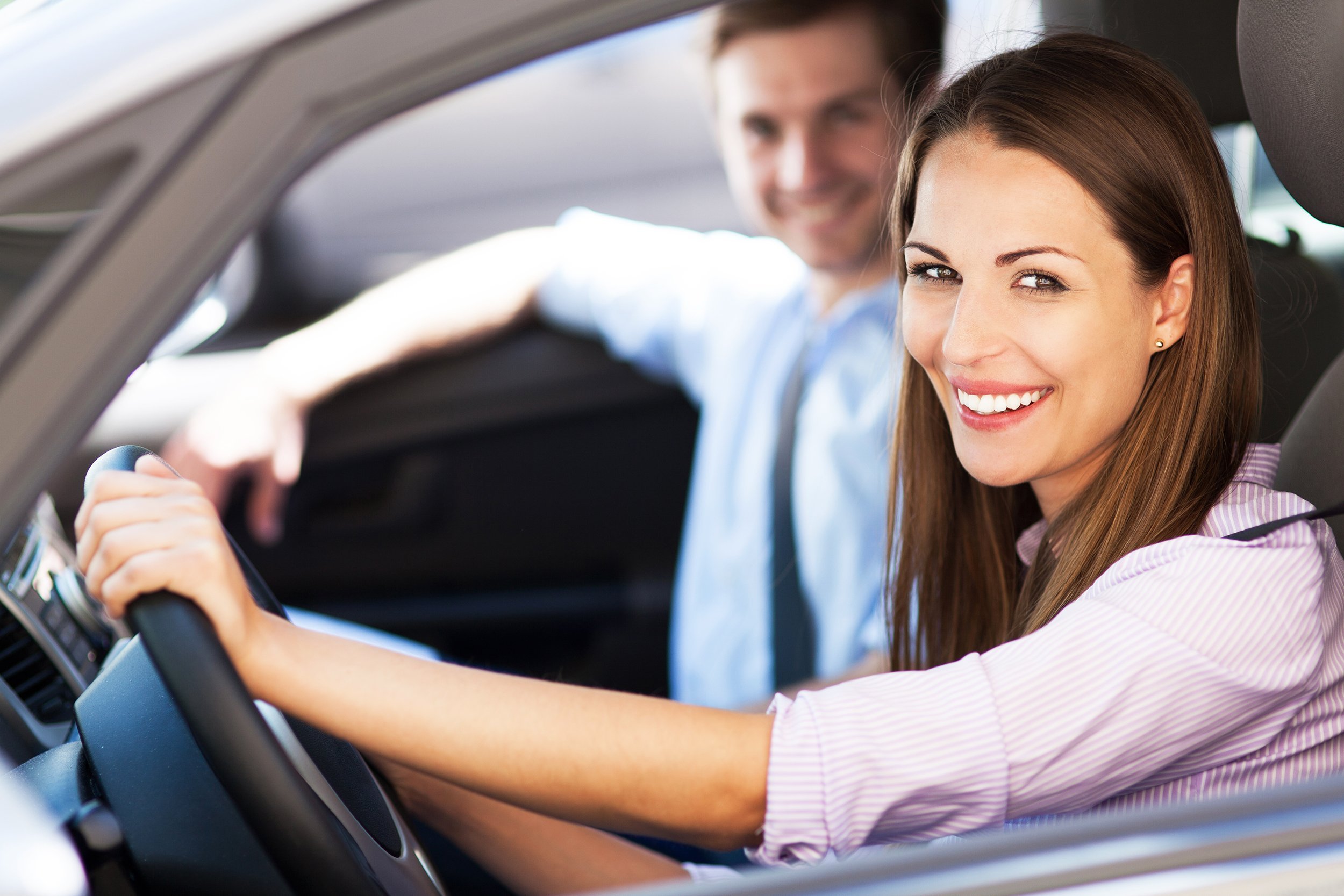 young couple sitting in car