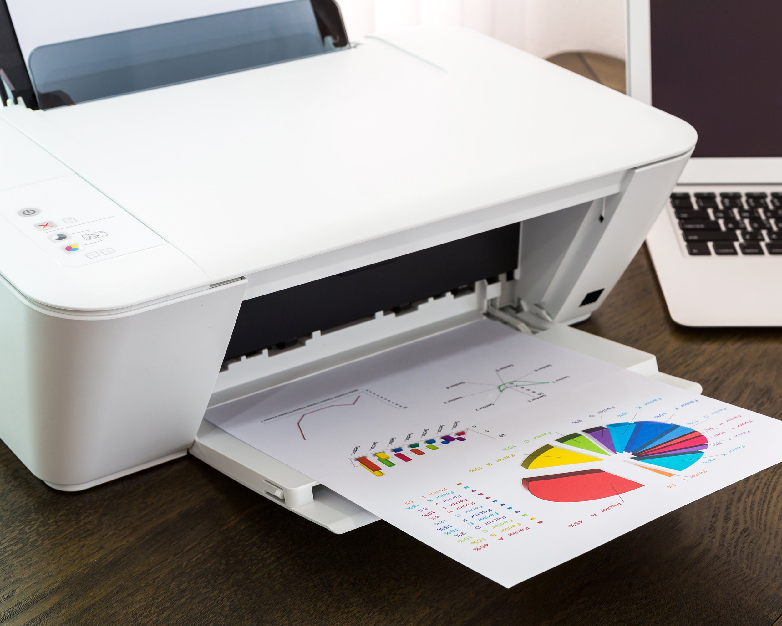 printer and laptop on wood table