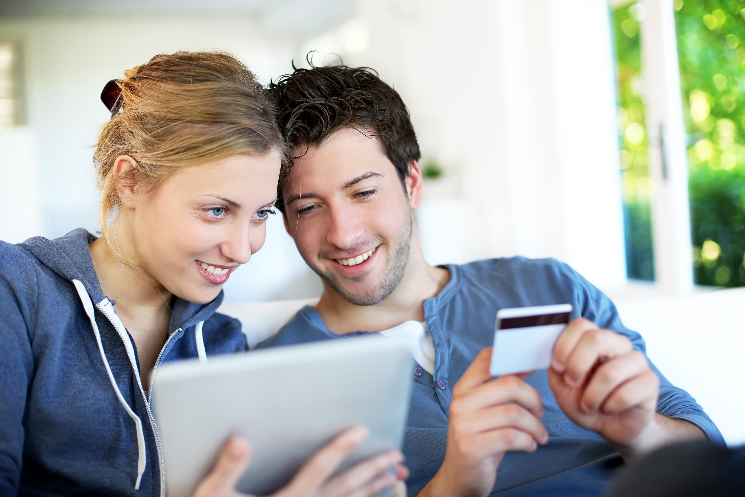 happy young couple doing shopping on internet