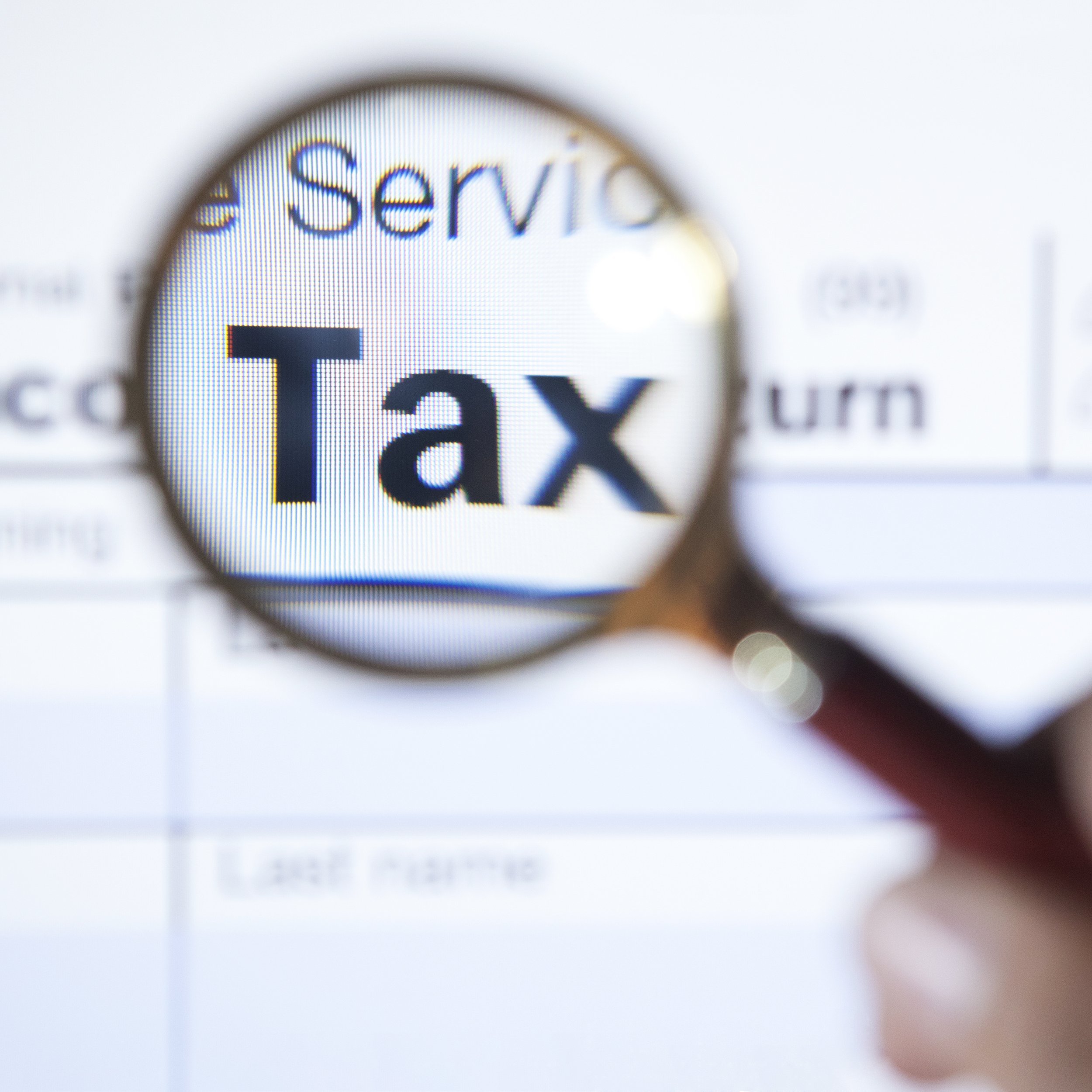 magnifying glass over the word tax on form 1040