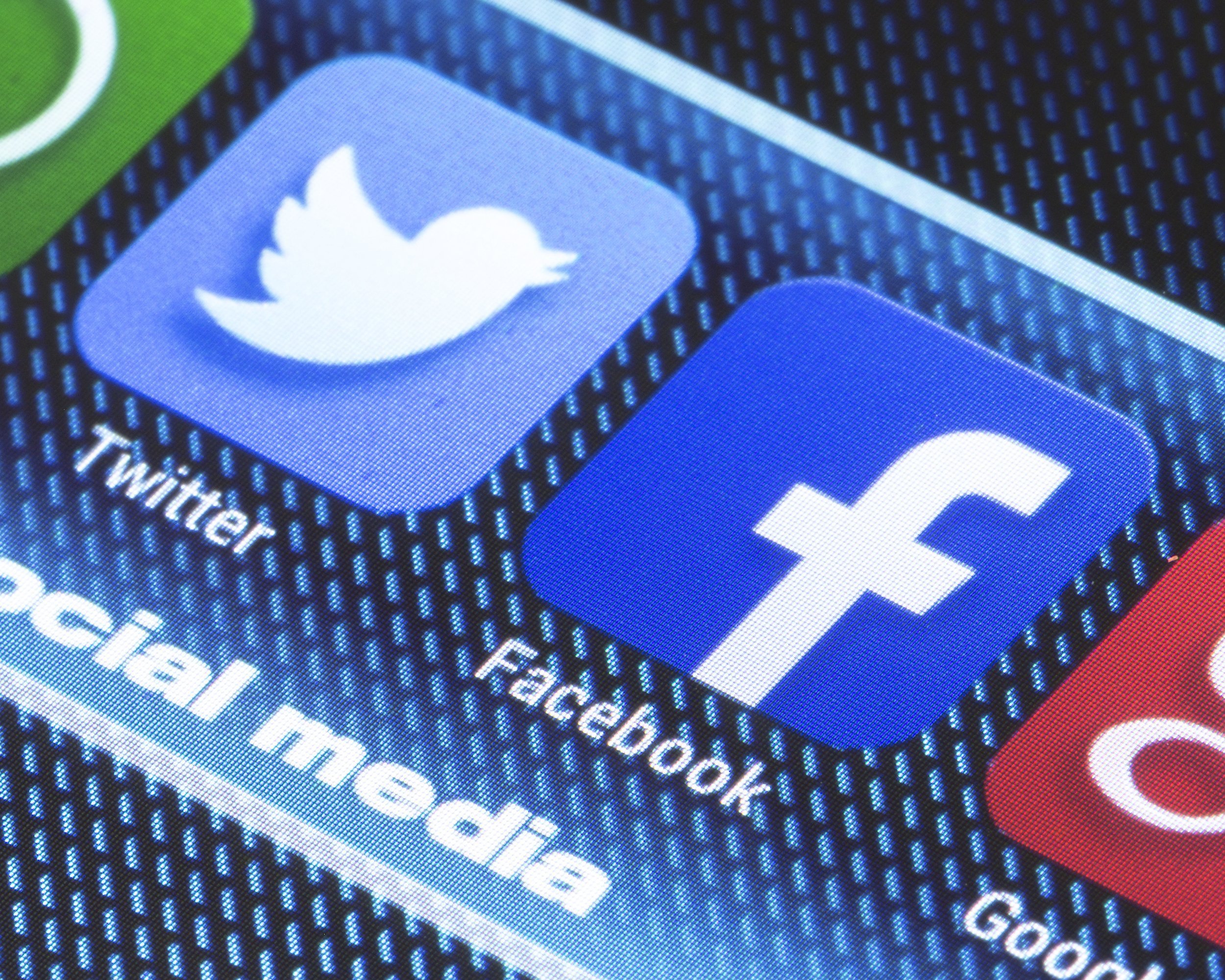 Twitter and Facebook social media icons on tablet