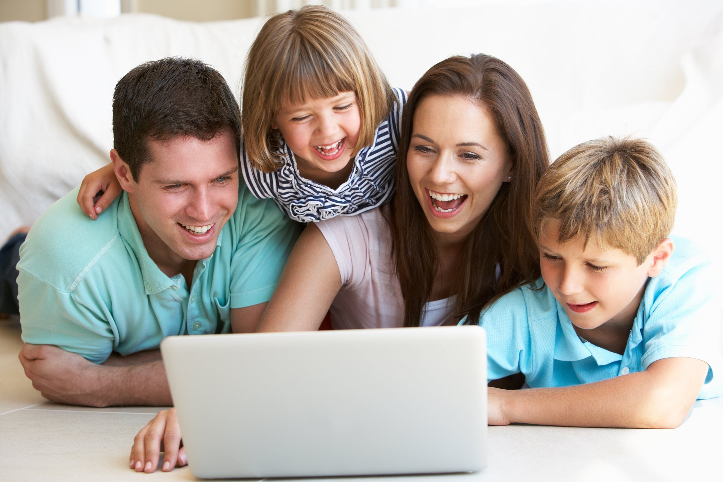 young parents with children on laptop computer