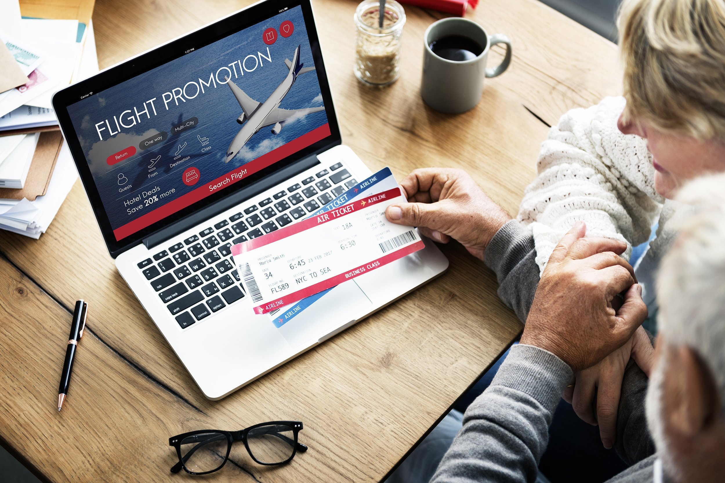 middle-aged couple booking flight on laptop