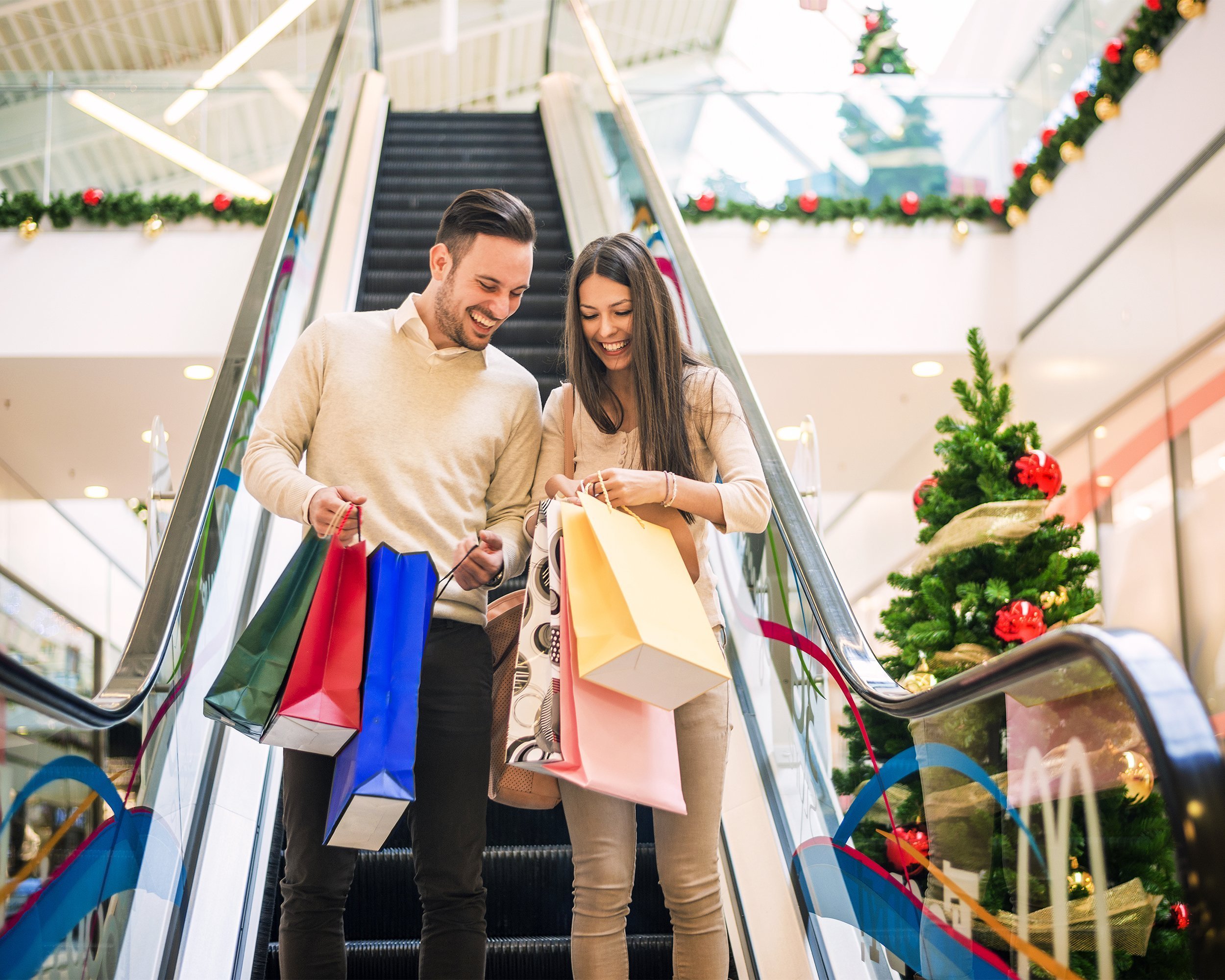 couple with shopping bags in mall at Christmas time