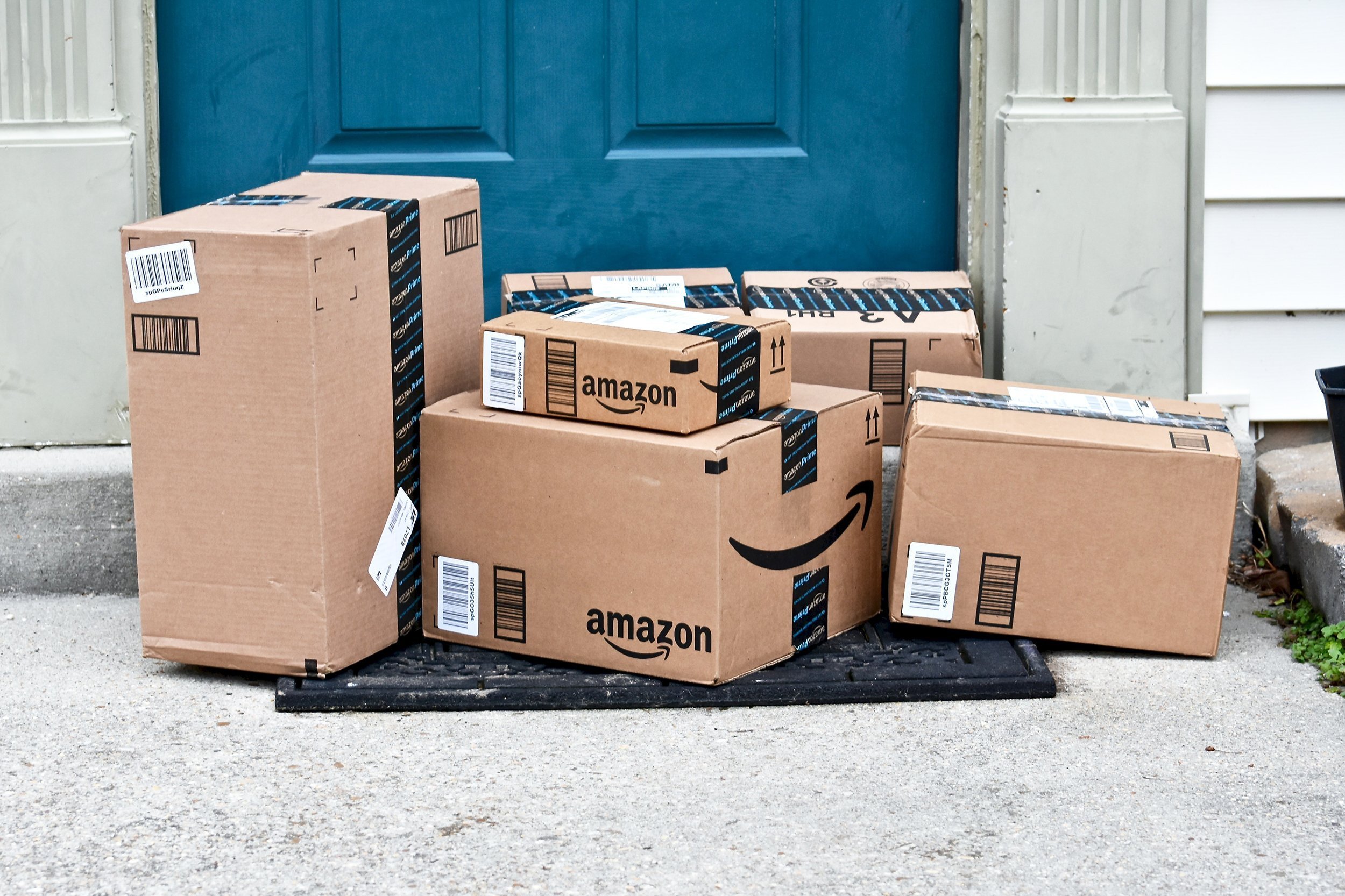 Amazon packages delivered to a home on the front doorstep