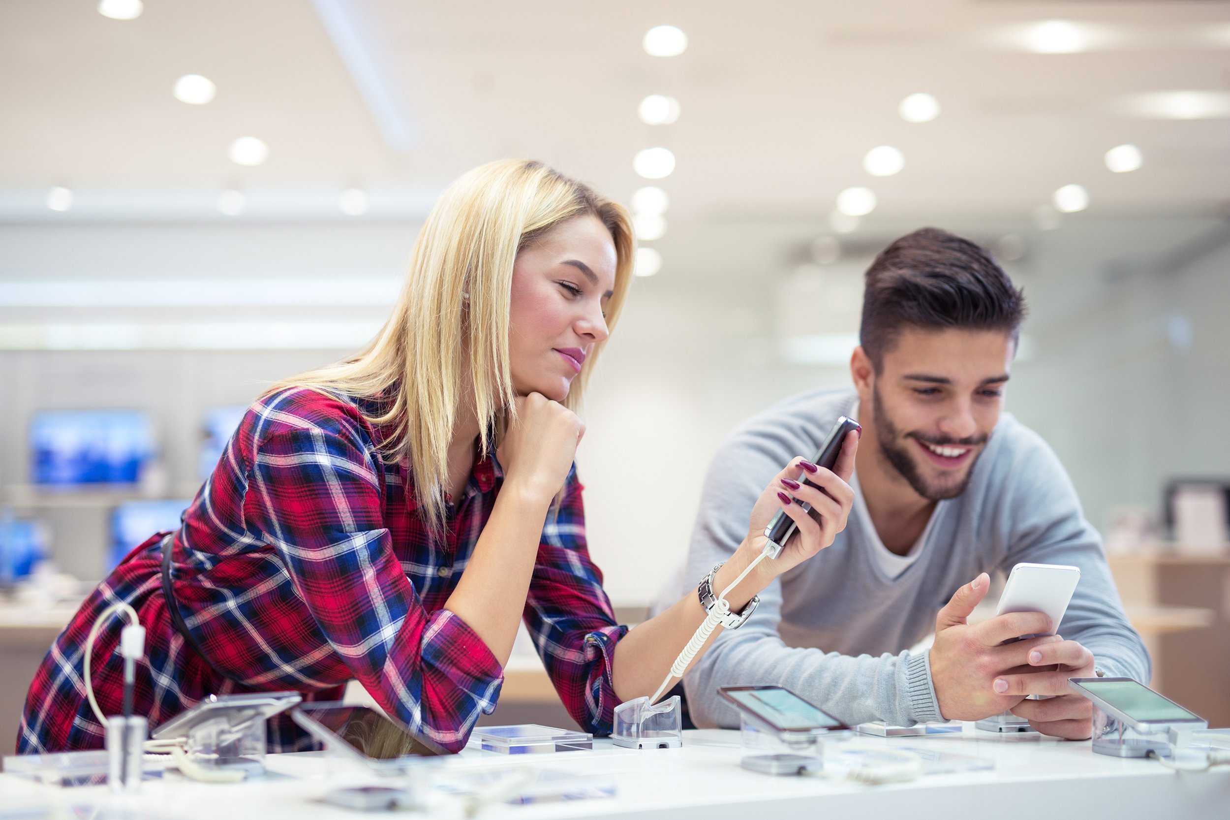 couple shopping a new mobile phone in the store