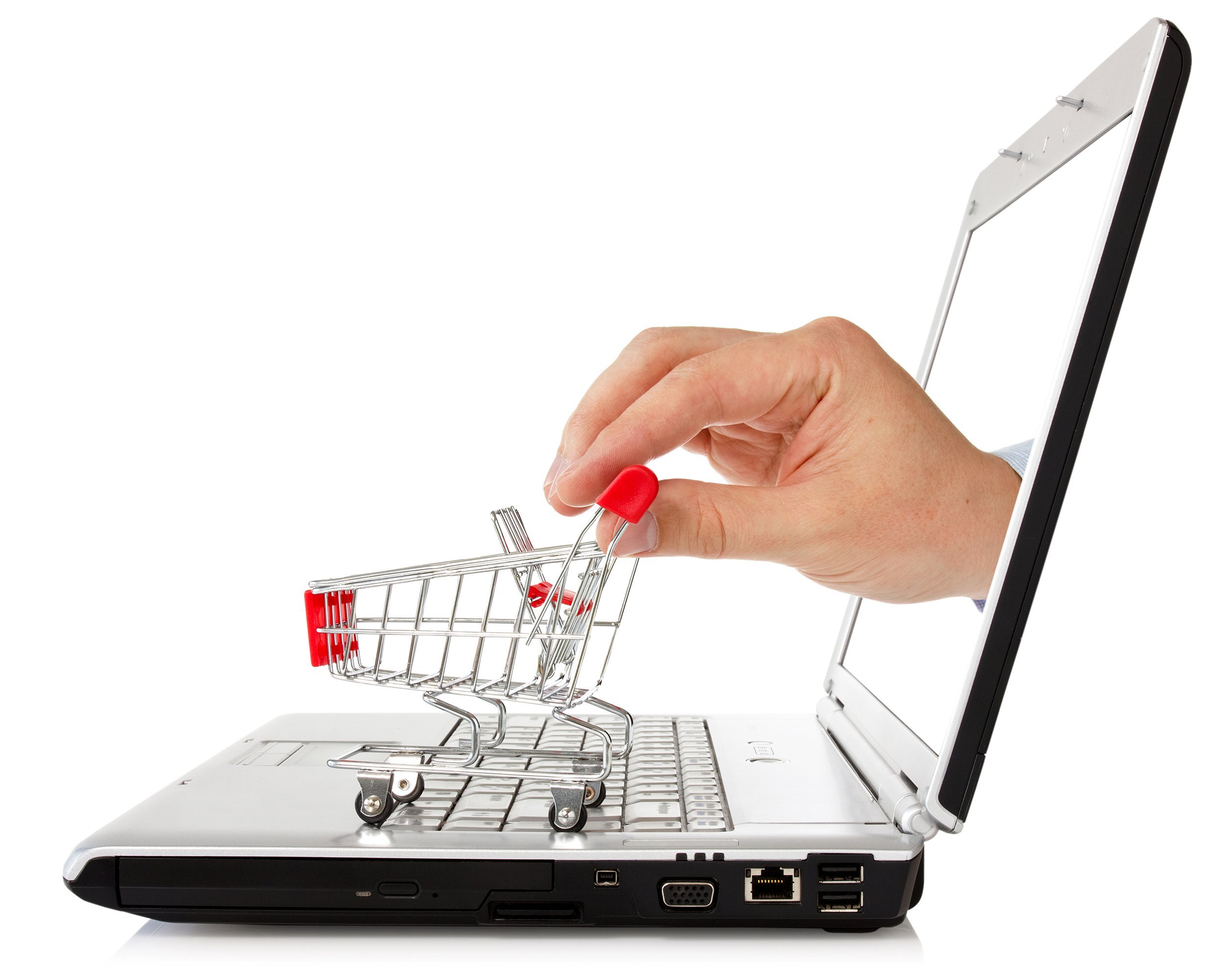 hand reaches out of a laptop with a shopping cart