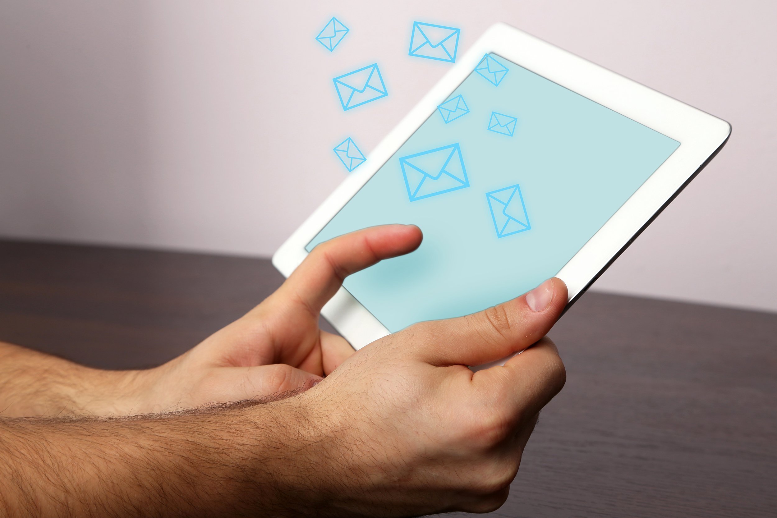emails coming out of tablet and hands