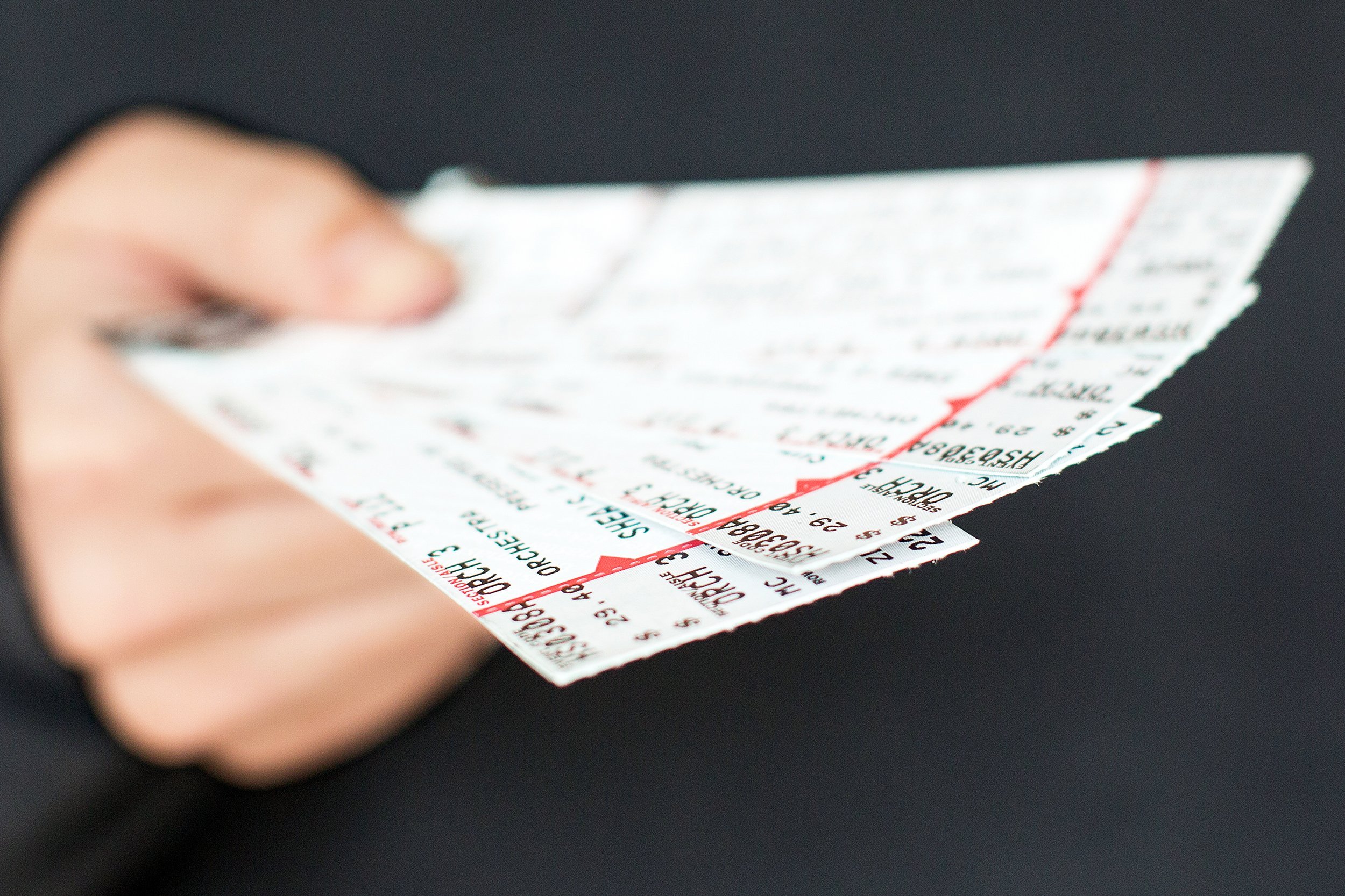 tickets being held in a hand