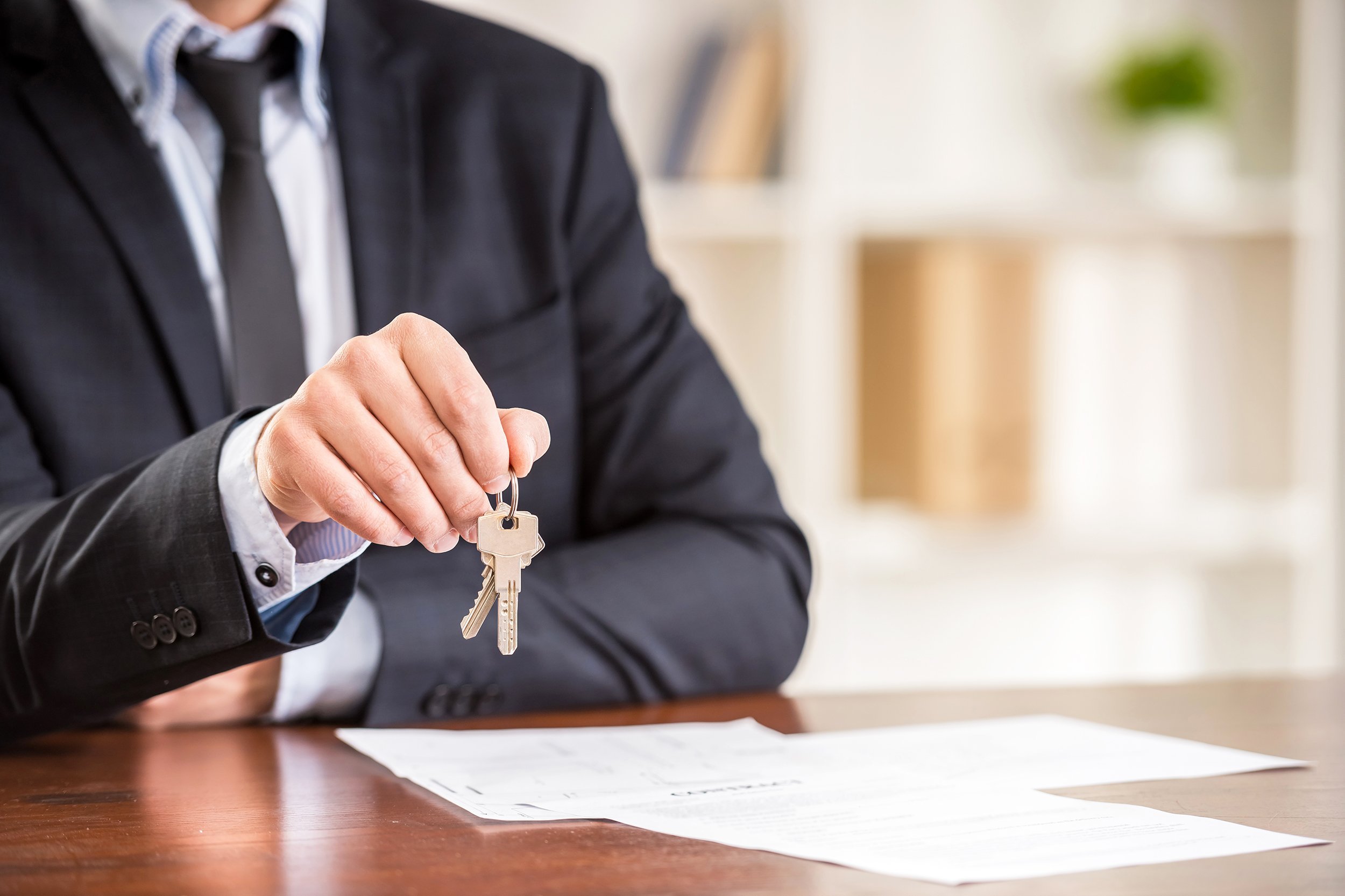 close-up of hand of man is holding a key from a new apartment