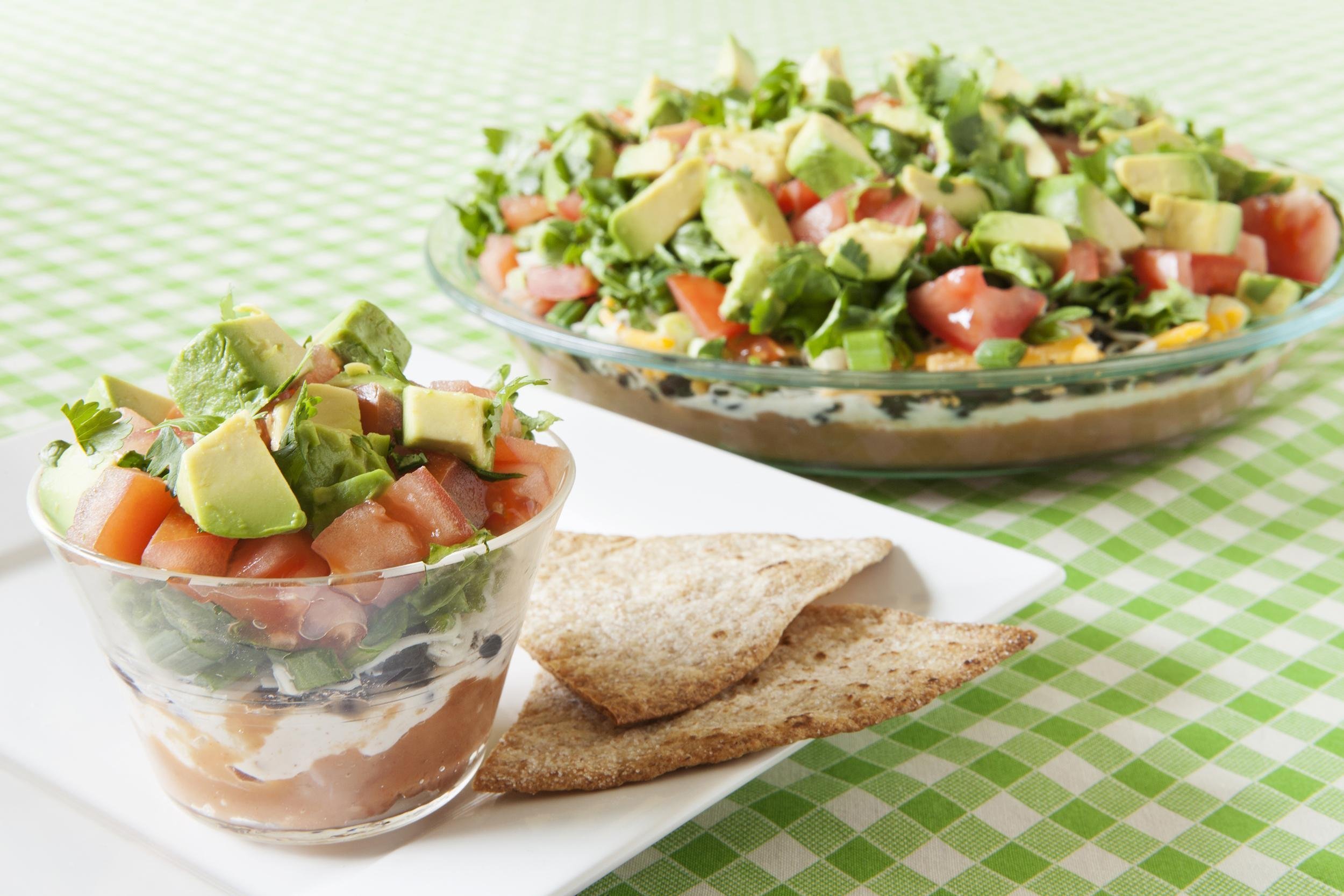 low fat layered Mexican dip in dishes on the table