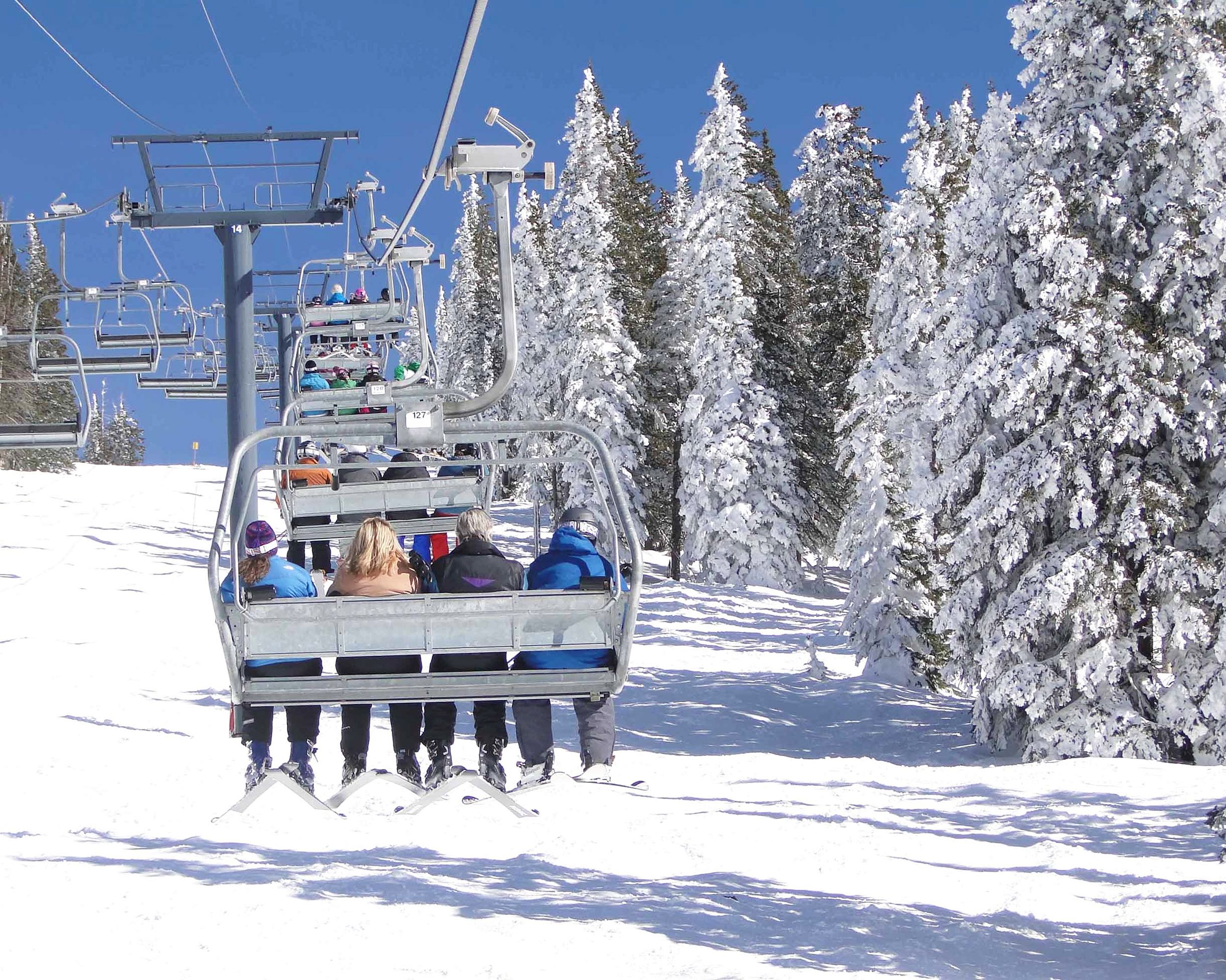 Skiers ride the chairlift at Steamboat Springs, Colorado