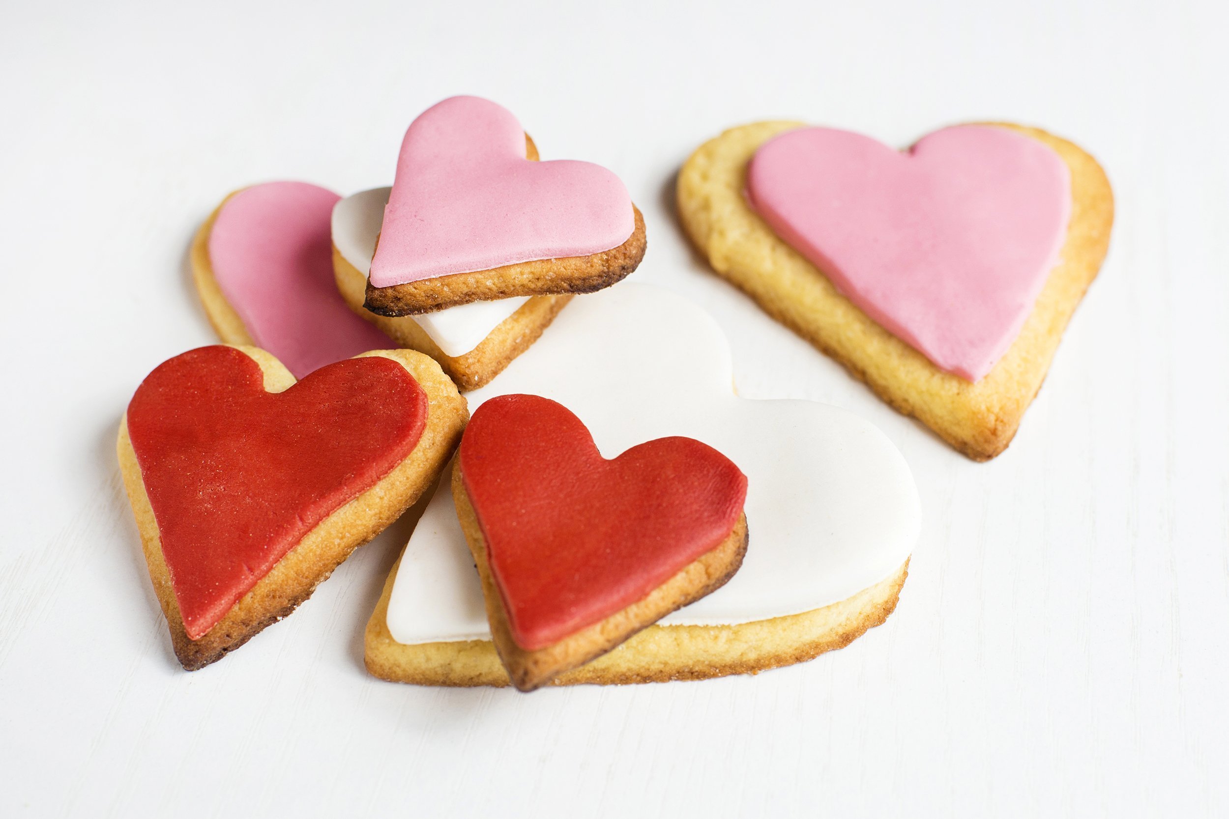 handmade cookies with heart shape on white wood