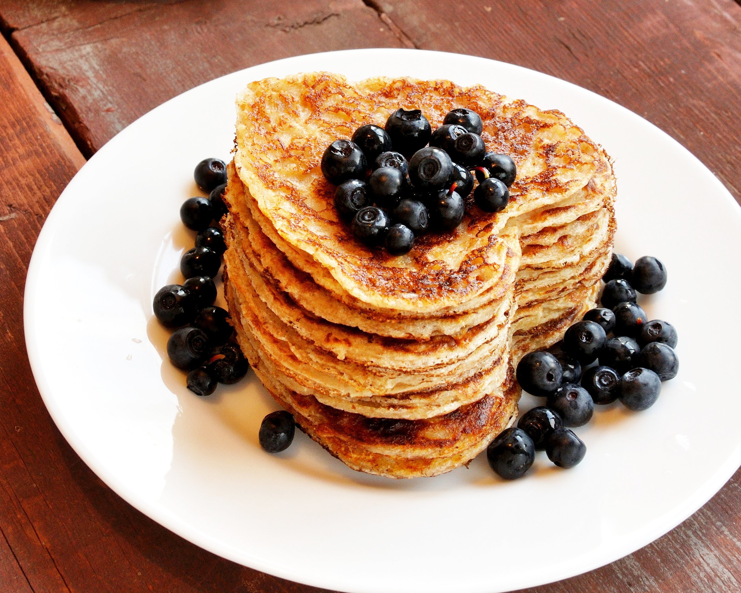 heart-shaped pancakes with blueberry on wooden table