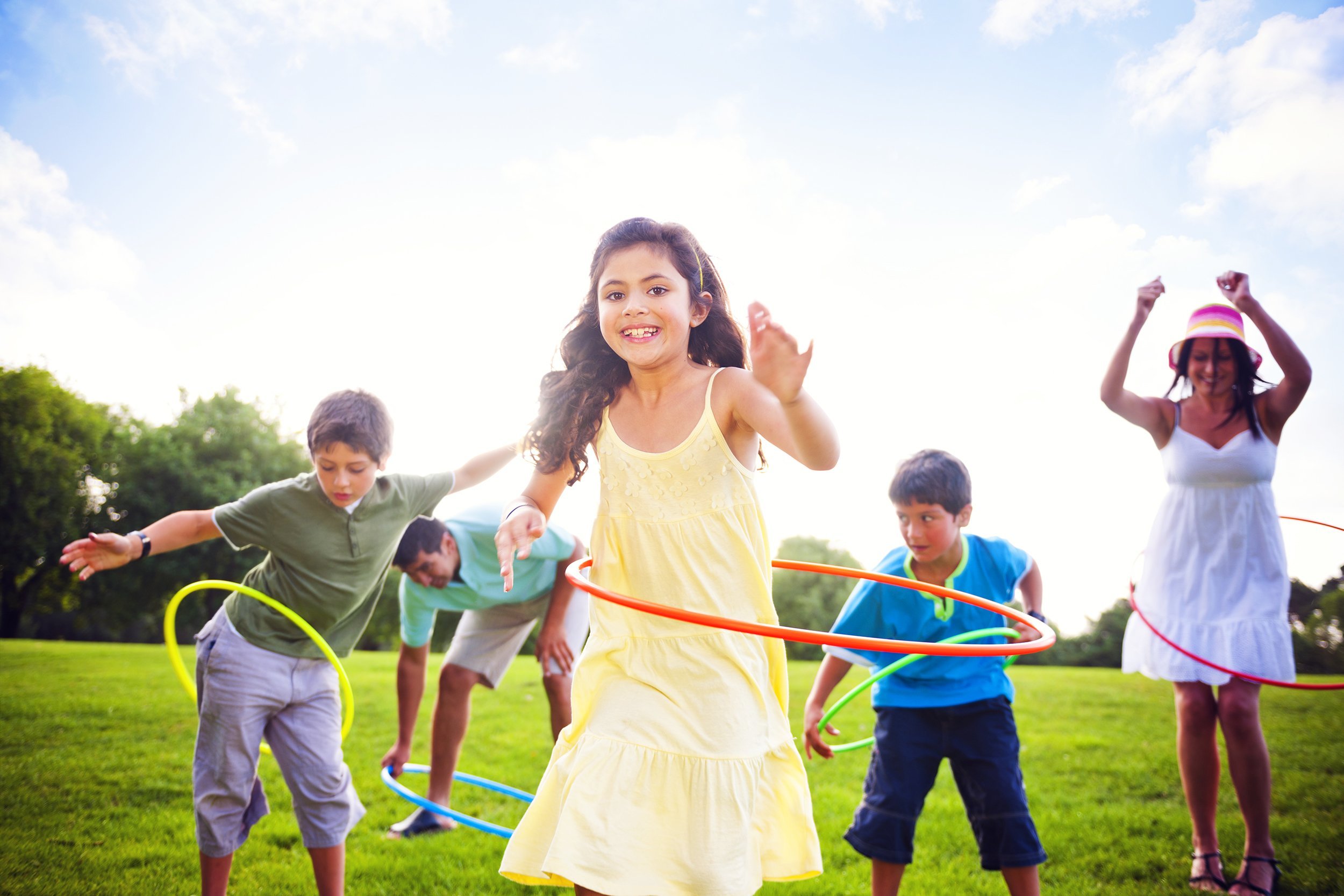 whole family hula hooping outdoors