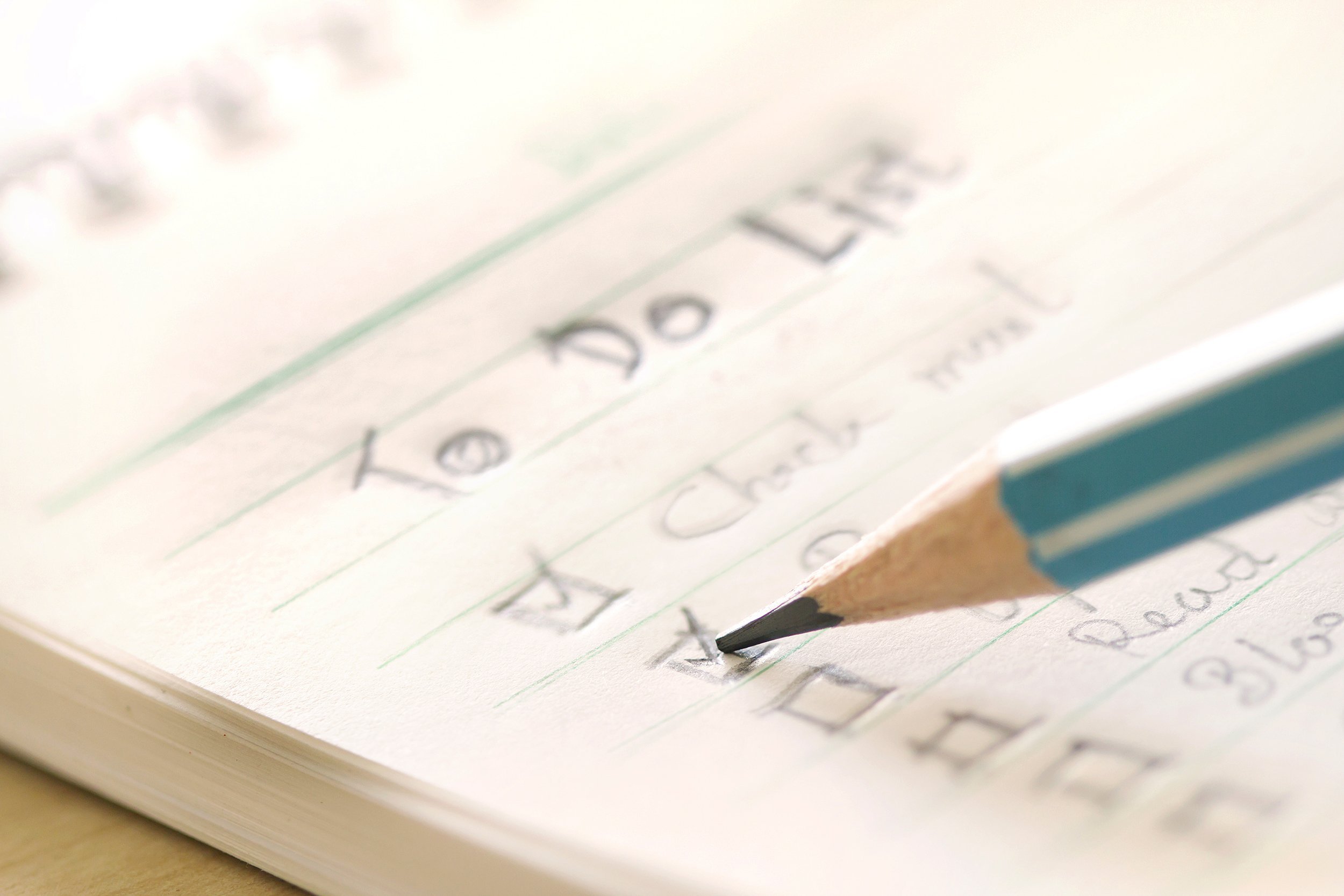close up handwritten to-do list plan in a small note book