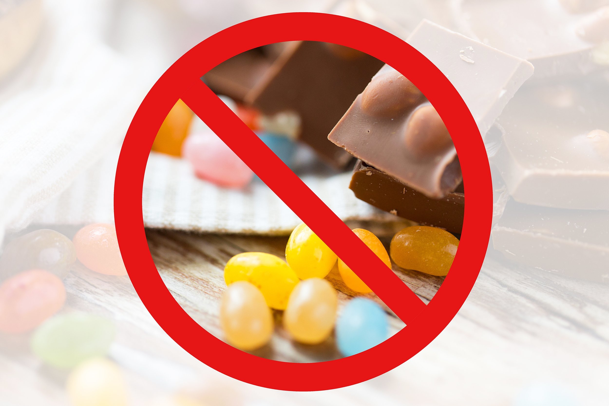 close up of jelly beans candies and chocolate behind no symbol or circle-backslash prohibition sign