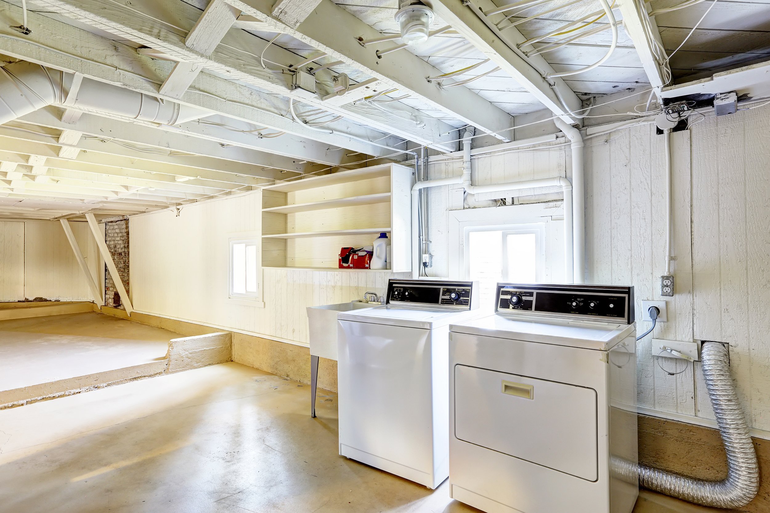 spacious empty basement with laundry in house