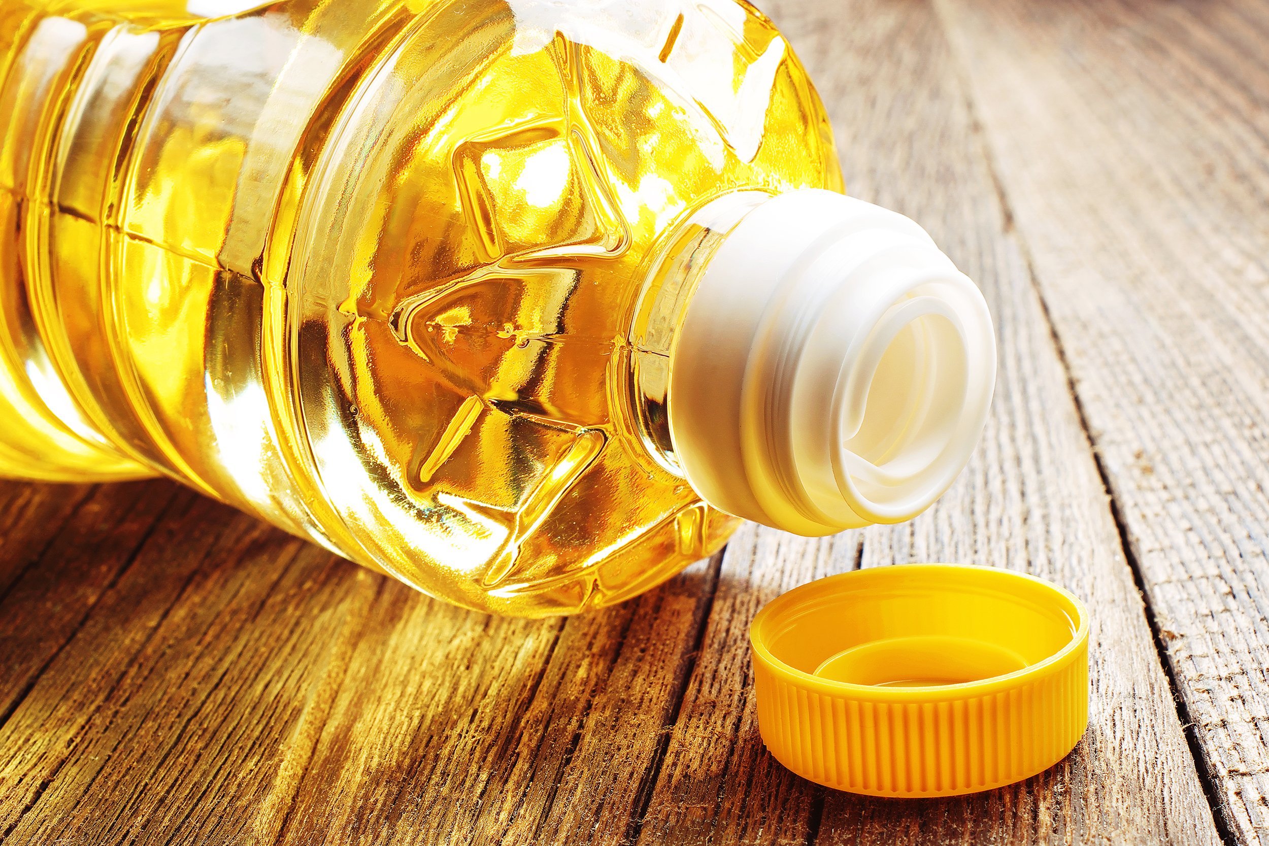 vegetable oil in plastic bottle on wooden table
