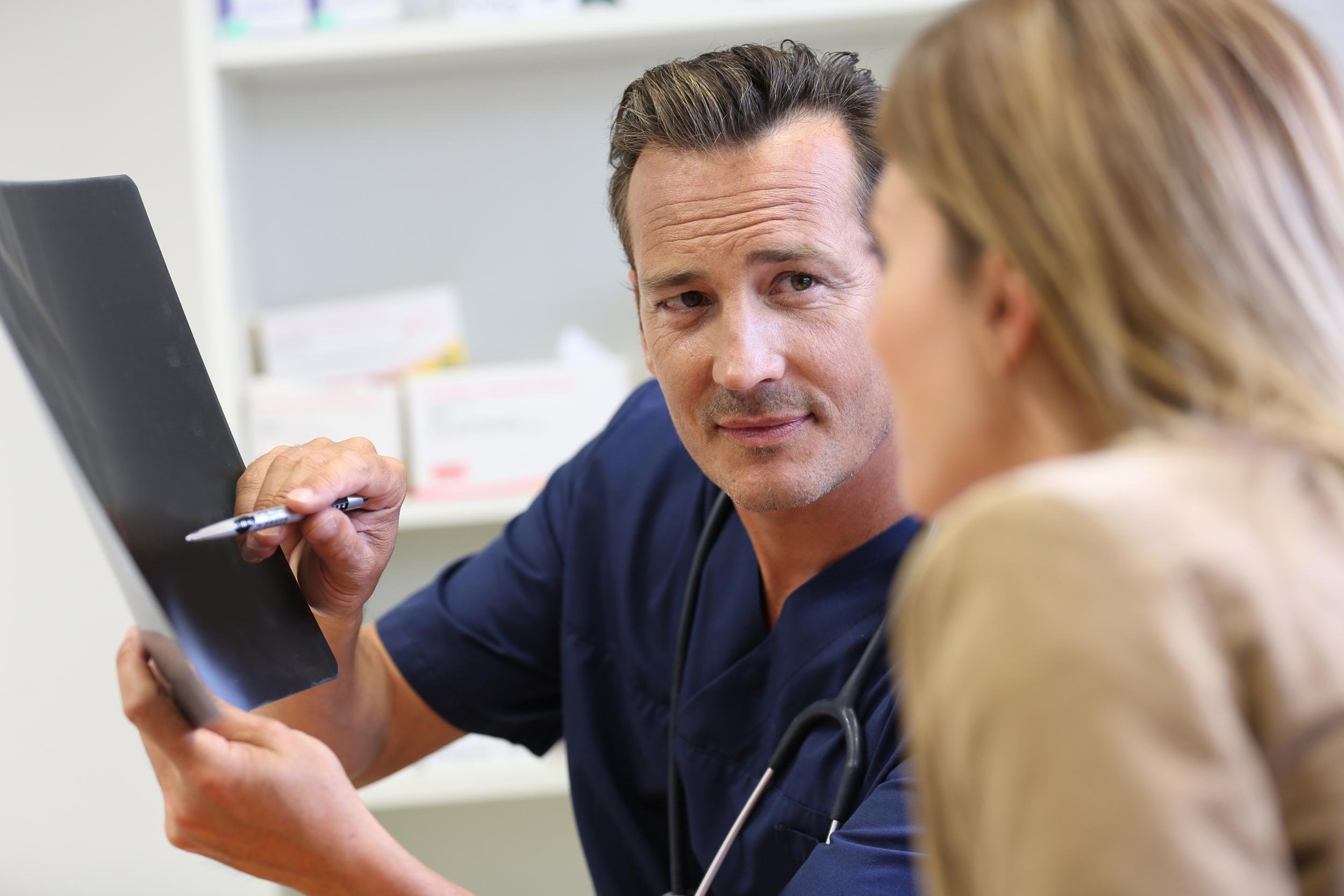 veterinarian showing x-ray result to client
